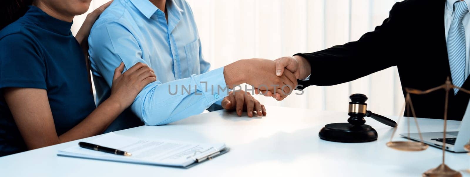 Couple shake hand with their lawyer after successfully completing marriage certification and receiving legal marriage consultation assistance from law firm. Panorama Rigid