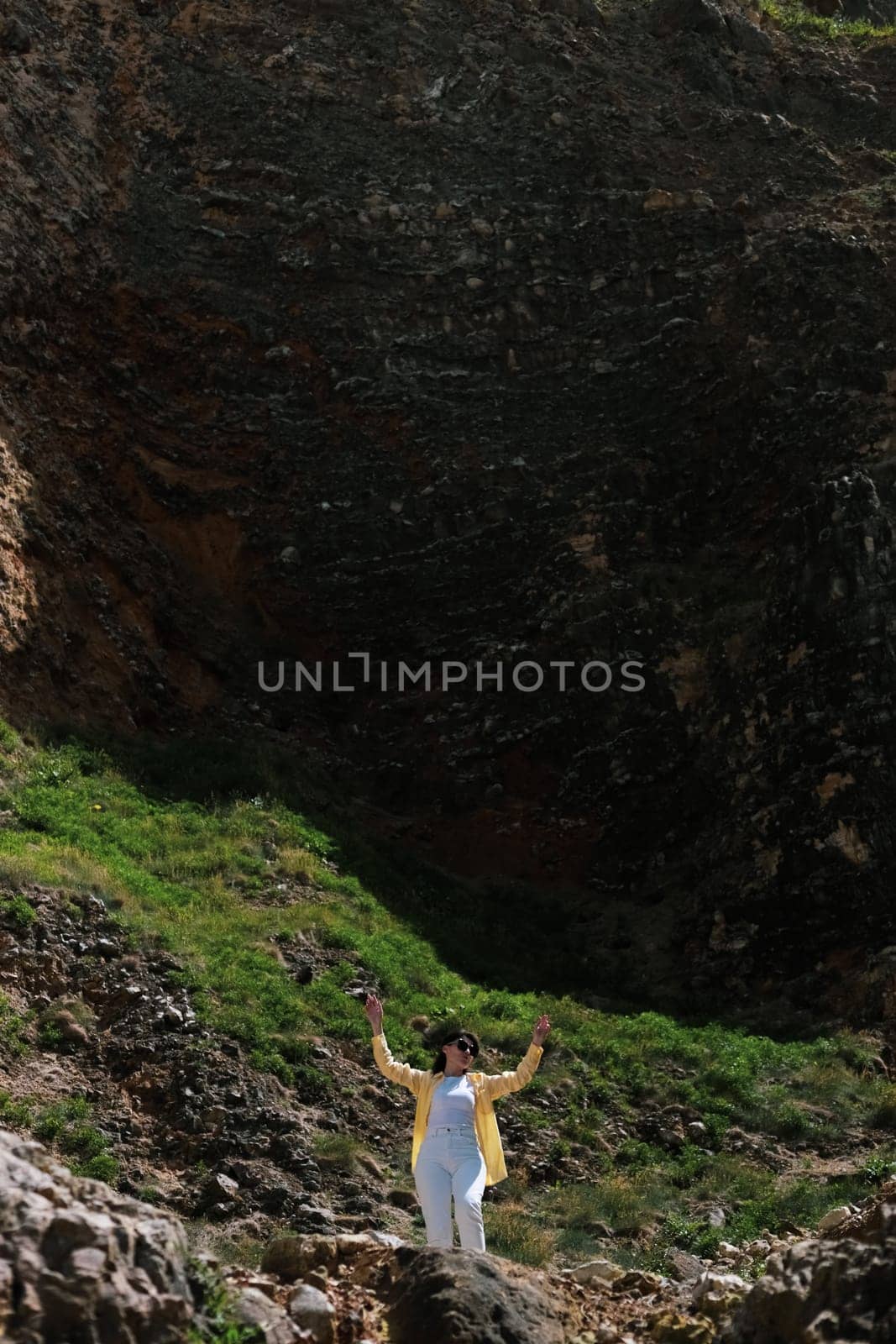 A young girl climbs the stairs on the rock. by Nataliya