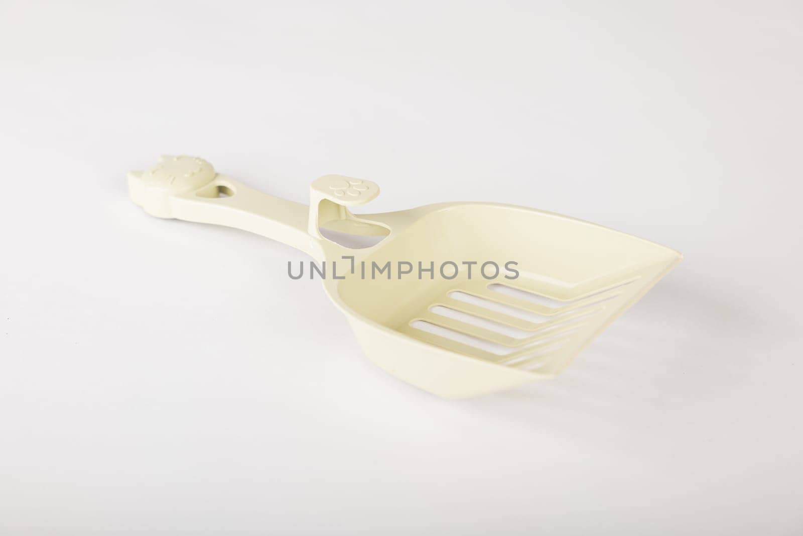 Isolated on a clean white background metal cat litter scoops are essential for maintaining hygiene and cleanliness in your cat's litter box. Purity and care are a scoop away.