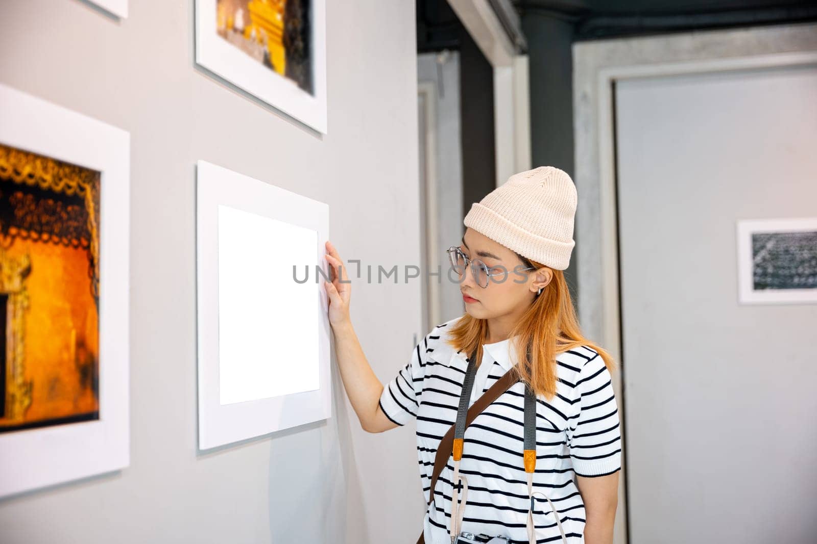 Photographer visit at photo frame to leaning against at show exhibit artwork gallery by Sorapop