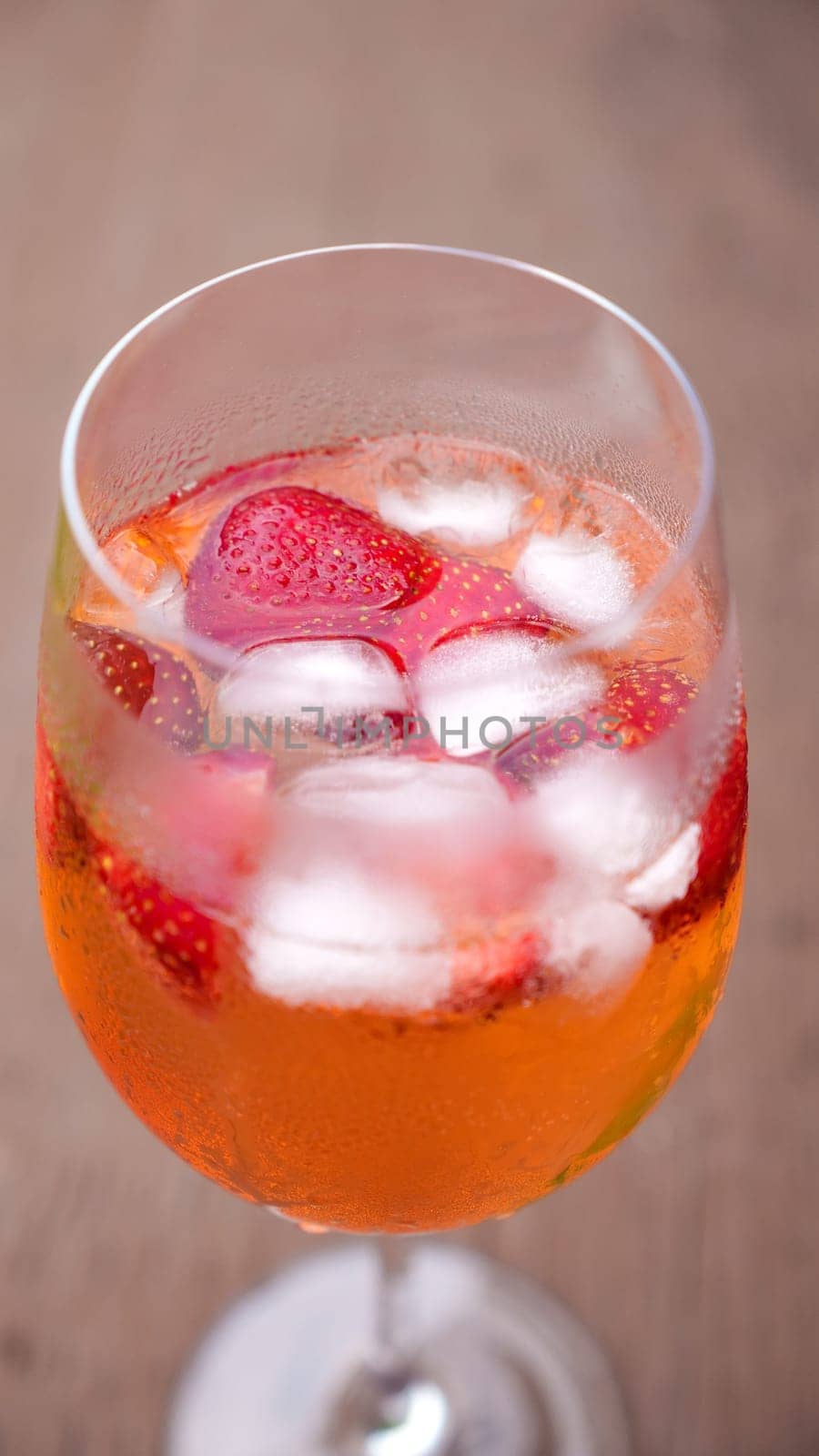 Fresh summer cocktail with strawberry and ice cubes. Glass of strawberry soda drink on dark background. Fresh strawberry cocktail. by JuliaDorian