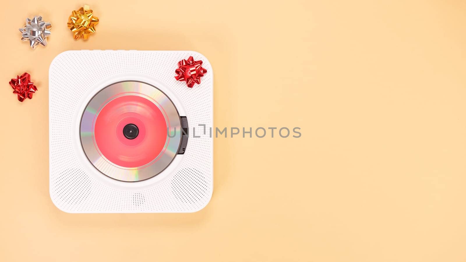 White cd player with red disc on yellow background. Love music, Valentine day, Greeting, retro Love song, space for text. by JuliaDorian
