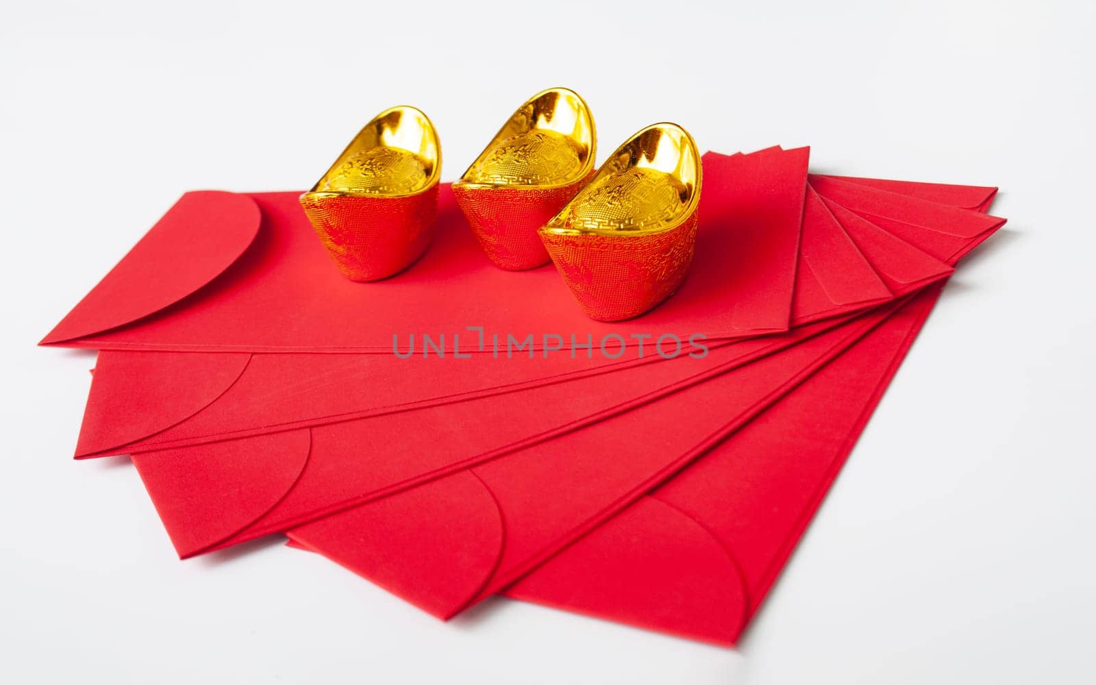 Chinese New Year red packet and golden ingot on white cover. Chinese New Year celebration concept