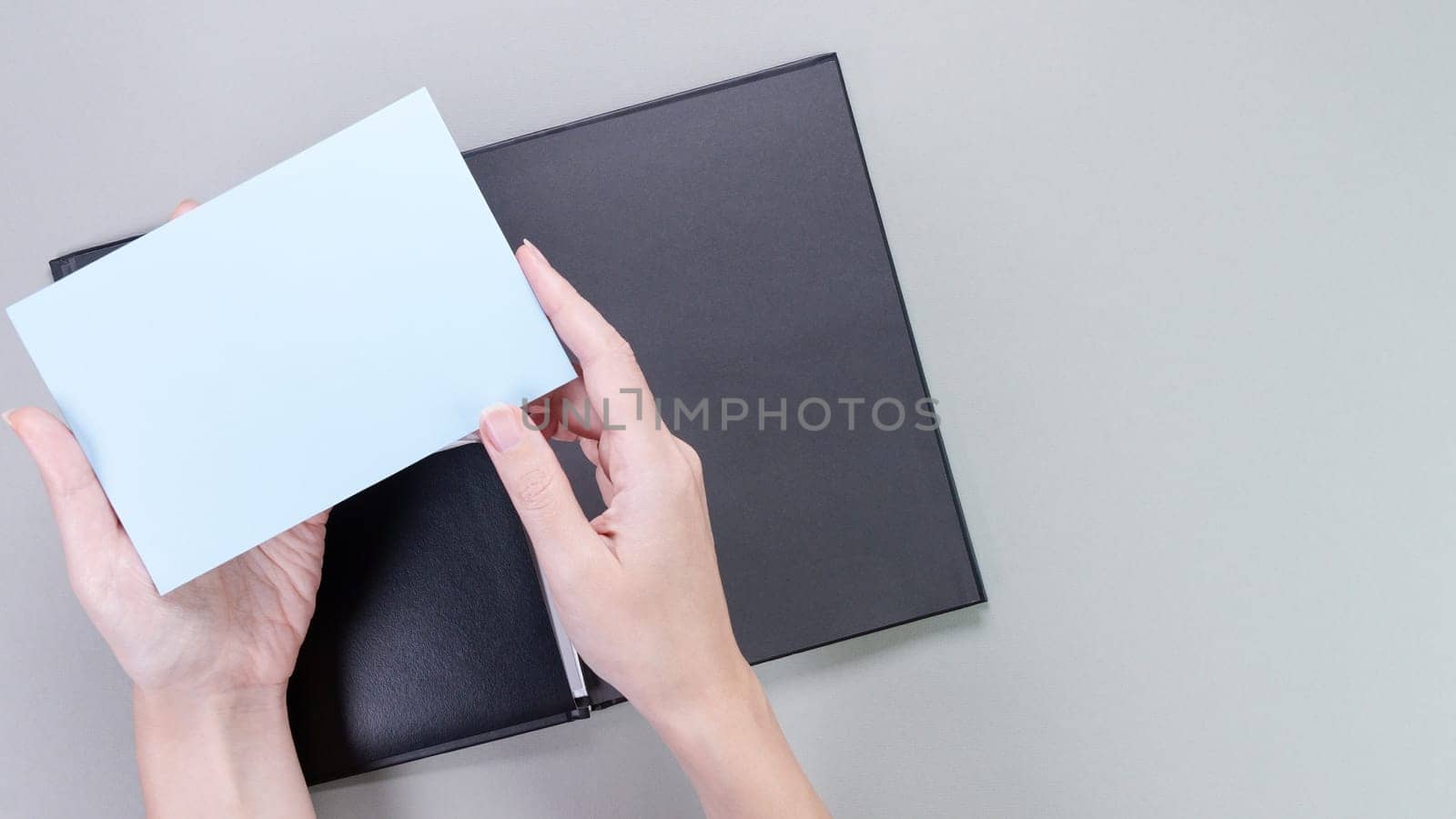 A square blue mockup card with empty space for text and design in hand of young woman on pink background. Color of year 2023 Viva Magenta. Board, blank, template, mockup, layout for a slogan. by JuliaDorian