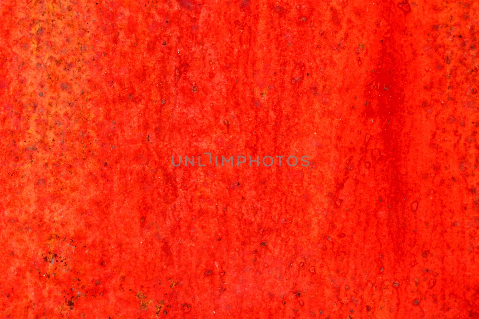 Red metal surface with spots creating textured wall background by darksoul72