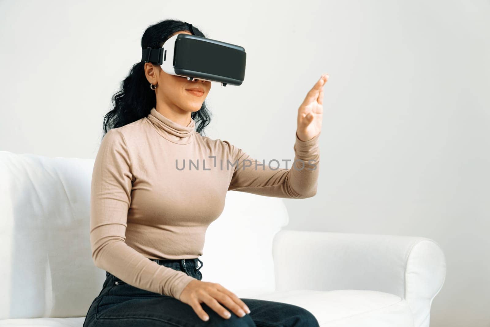 Young woman using virtual reality VR goggle at home for crucial online shopping experience. The virtual reality VR innovation optimized for female digital entertainment lifestyle.