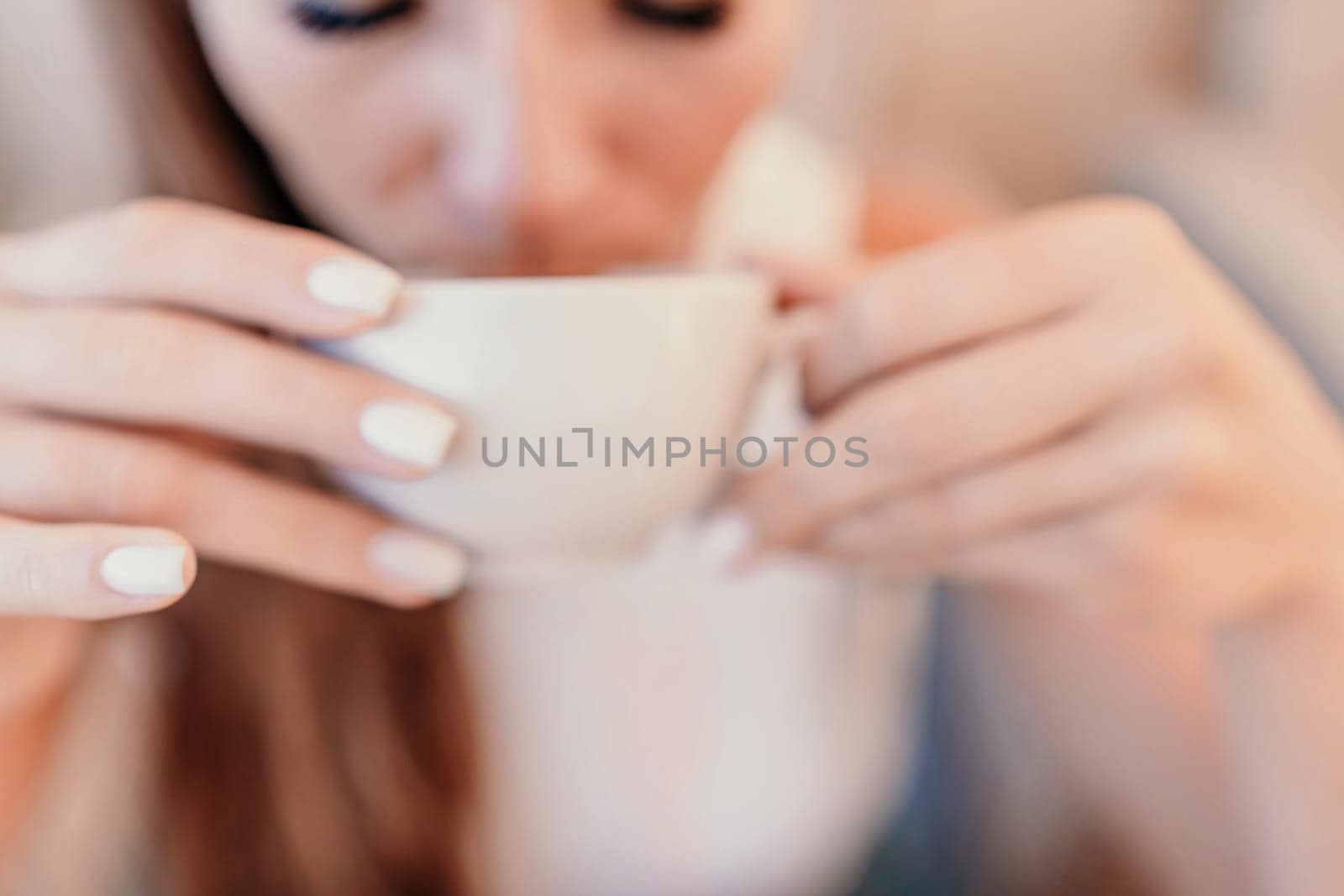 Woman coffee cafe. Coffee break in cafe. Tranquil long haired woman drinking coffee