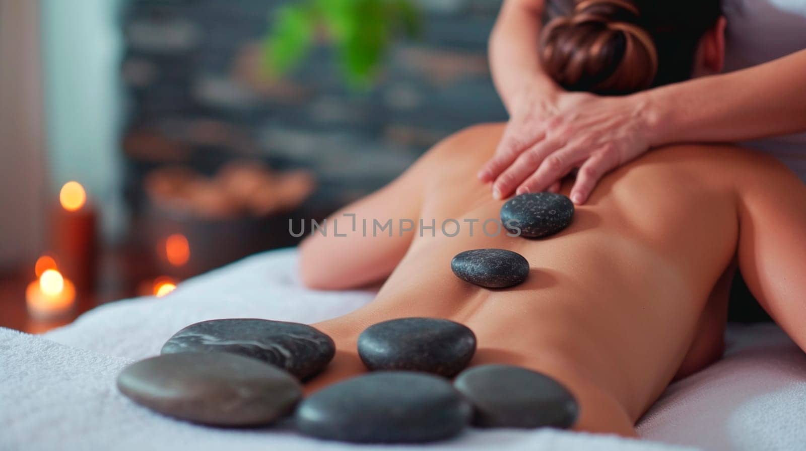 Woman in a spa salon massages stones. Selective focus. Relax.