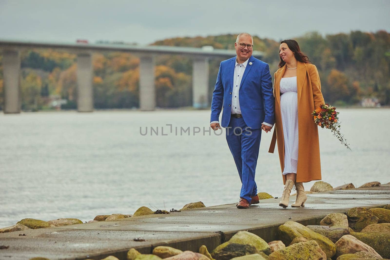Vejle, Denmark, October 26, 2023: Couple in love walking on the bridge.