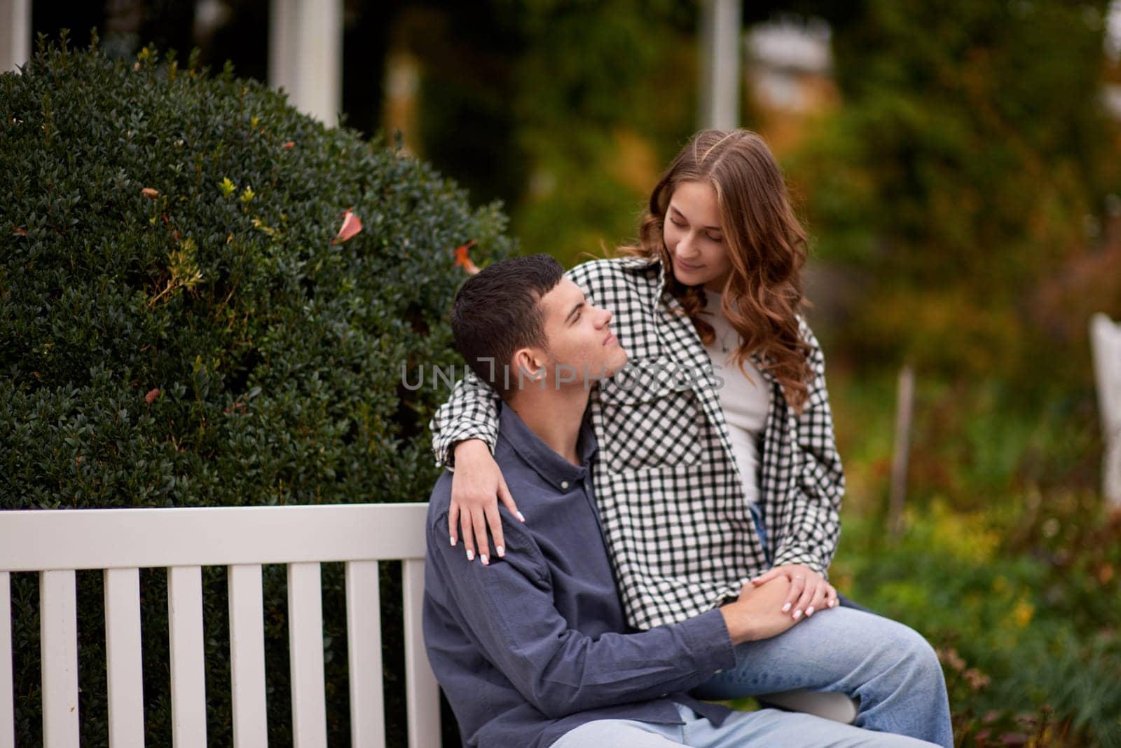 lovely young couple kissing outdoors in autumn. Loving couple walking in nature. Autumn mood. Happy man and woman hugging and kissing in autumn. Love. Fashionable couple outdoors. Fashion, people and lifestyle. Stylish couple in autumn outfit.