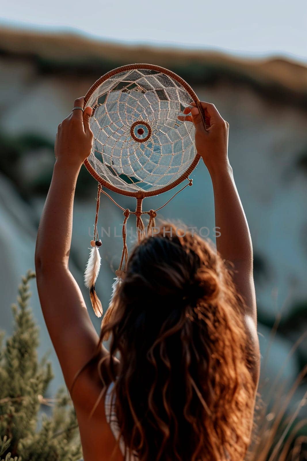 A woman makes a dream catcher. Selective focus. Hand.