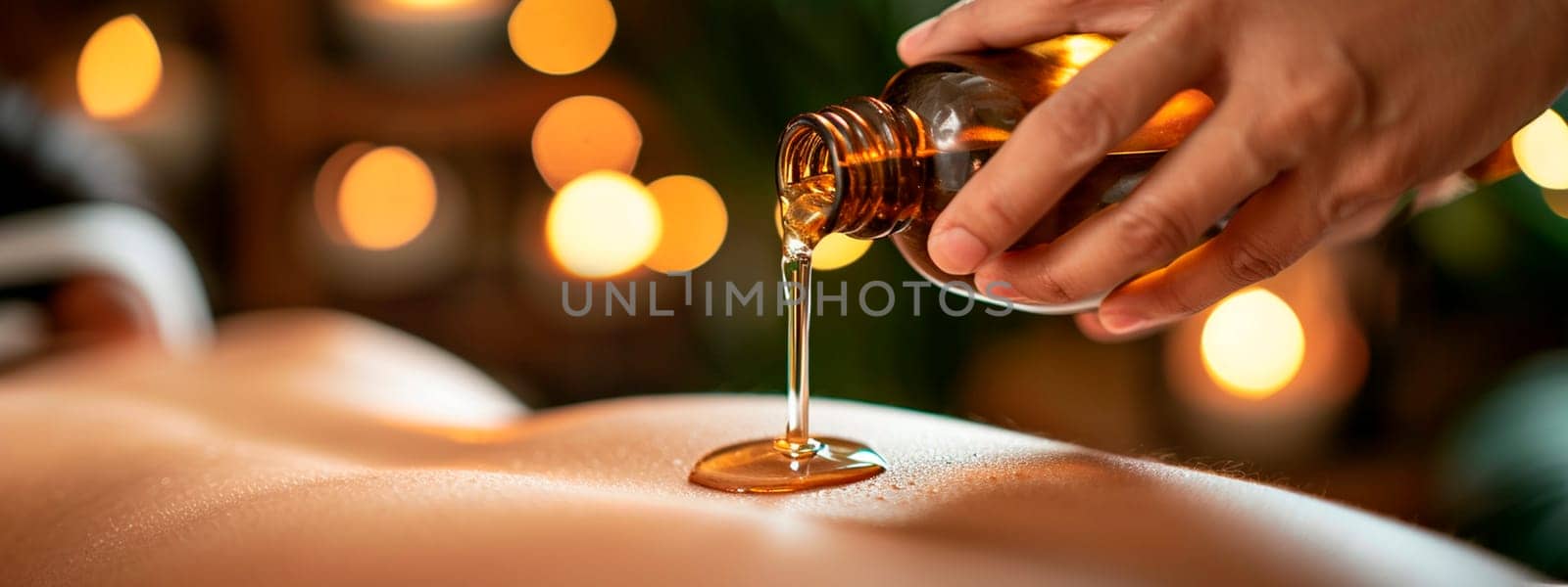 Cosmetic oil in a spa salon on a woman's back. Selective focus. People.