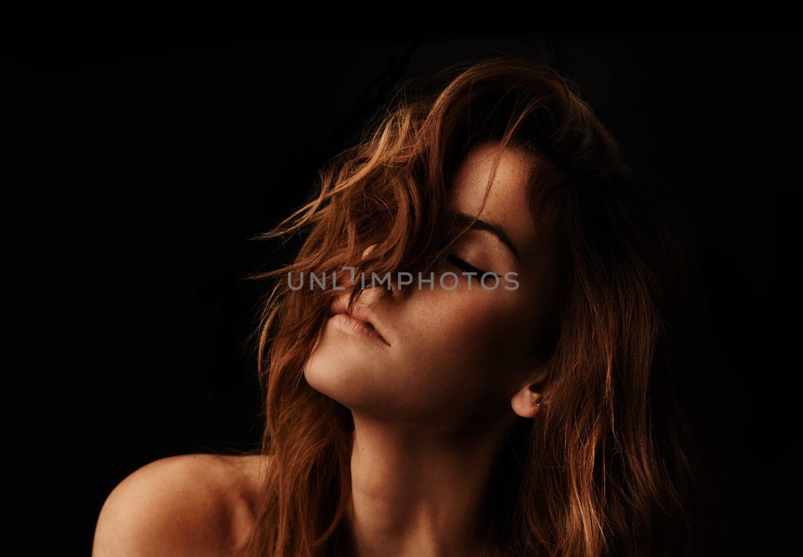 Woman, hair care and ginger with salon, cosmetic and shampoo treatment in a studio. Relax, beauty and female person with wavy texture and fresh haircut with balayage model with black background by YuriArcurs