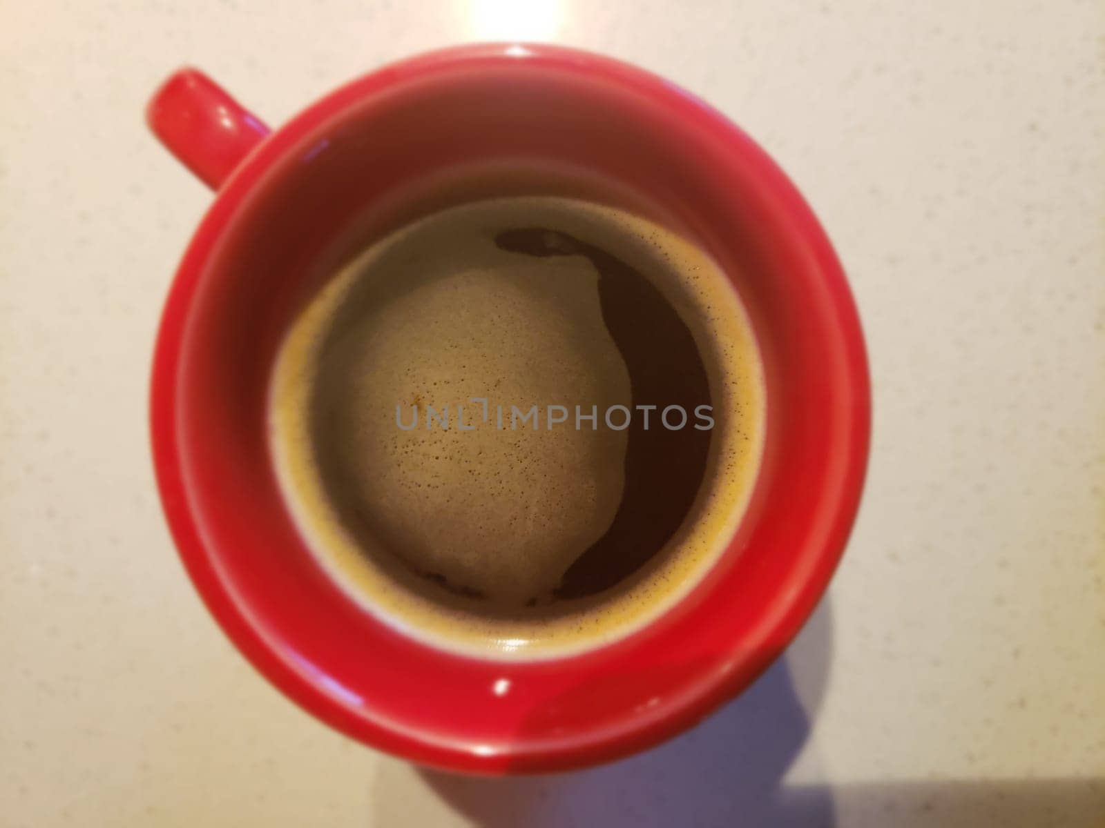 View of Coffee in a Red Mug Looking From Above