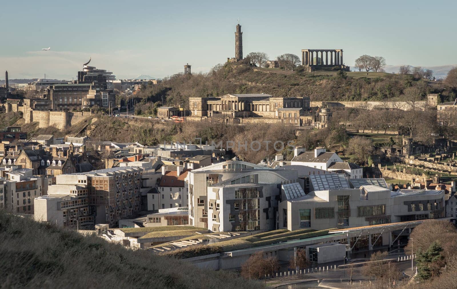 Edinburgh, Scotland - Jan 17, 2024 - Aerial view of Calton Hill, Scottish Parliament Building with the skyline seen from the top of Salisbury Crags. Amazing Edinburgh cityscape, Destinations in Europe, Copy space, Selective focus.