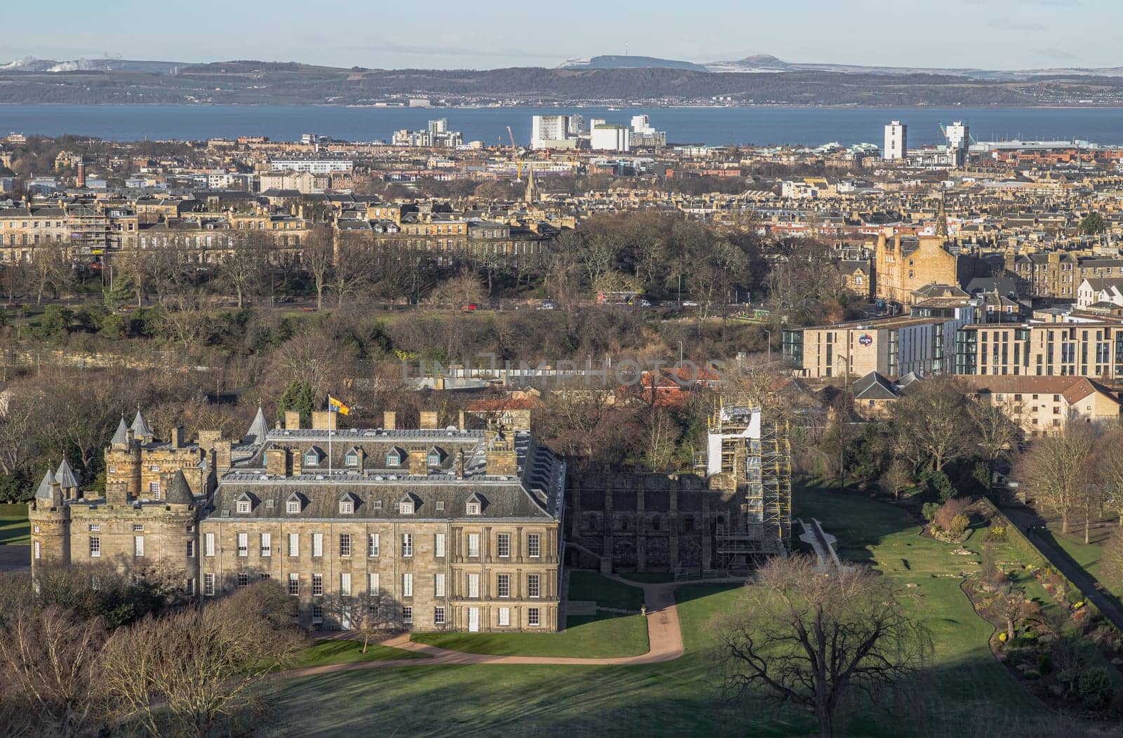 Edinburgh, Scotland - Jan 17, 2024 - Aerial view of Palace of Holyroodhouse and Holyrood Park seen from the top of Salisbury Crags. Amazing Edinburgh Cityscape, Destinations in Europe, Copy space, Selective focus.