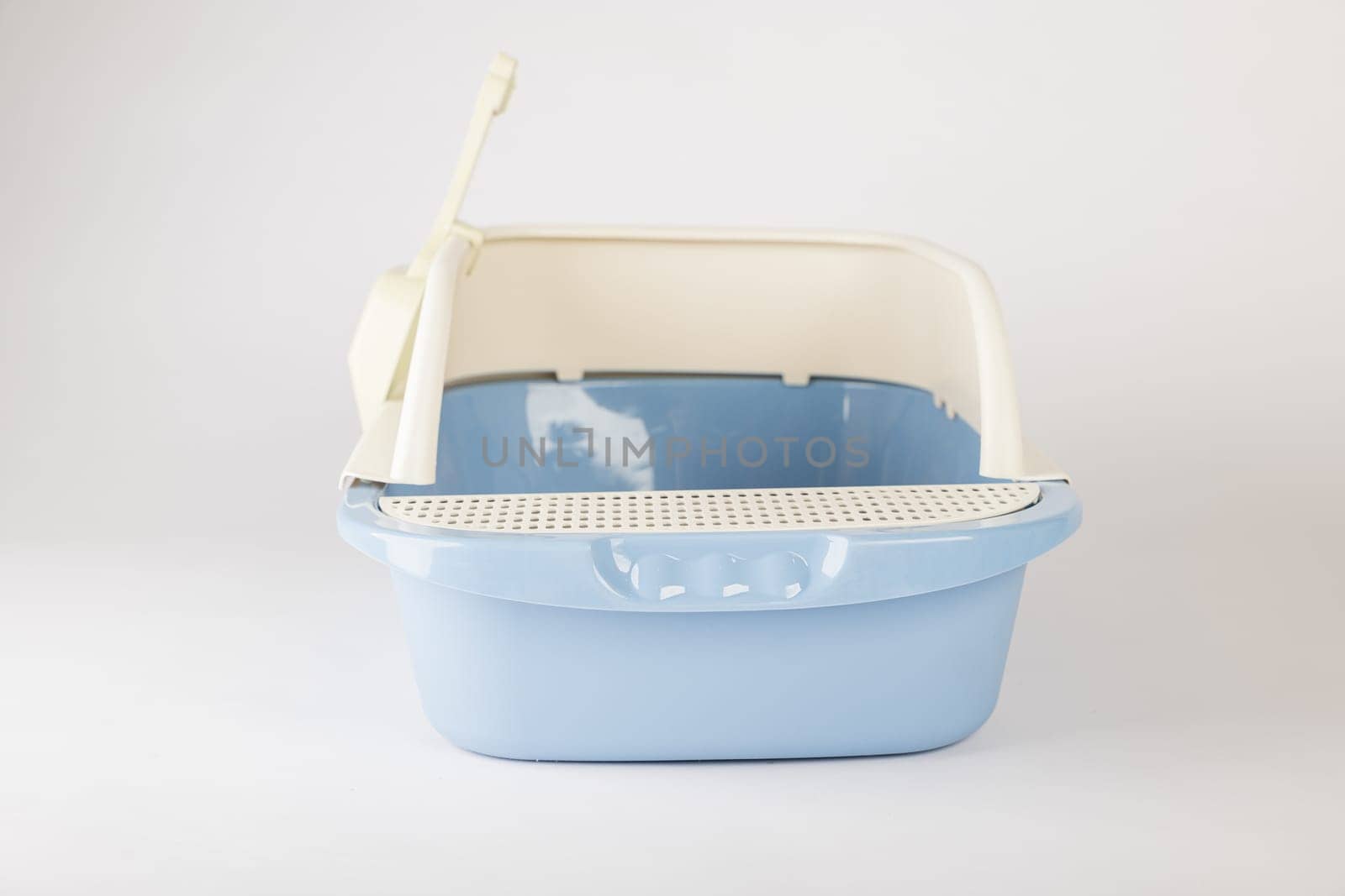 This isolated plastic cat litter toilet tray with scoop on a white background is essential for promoting hygiene and cleanliness in your pet's crate. by Sorapop