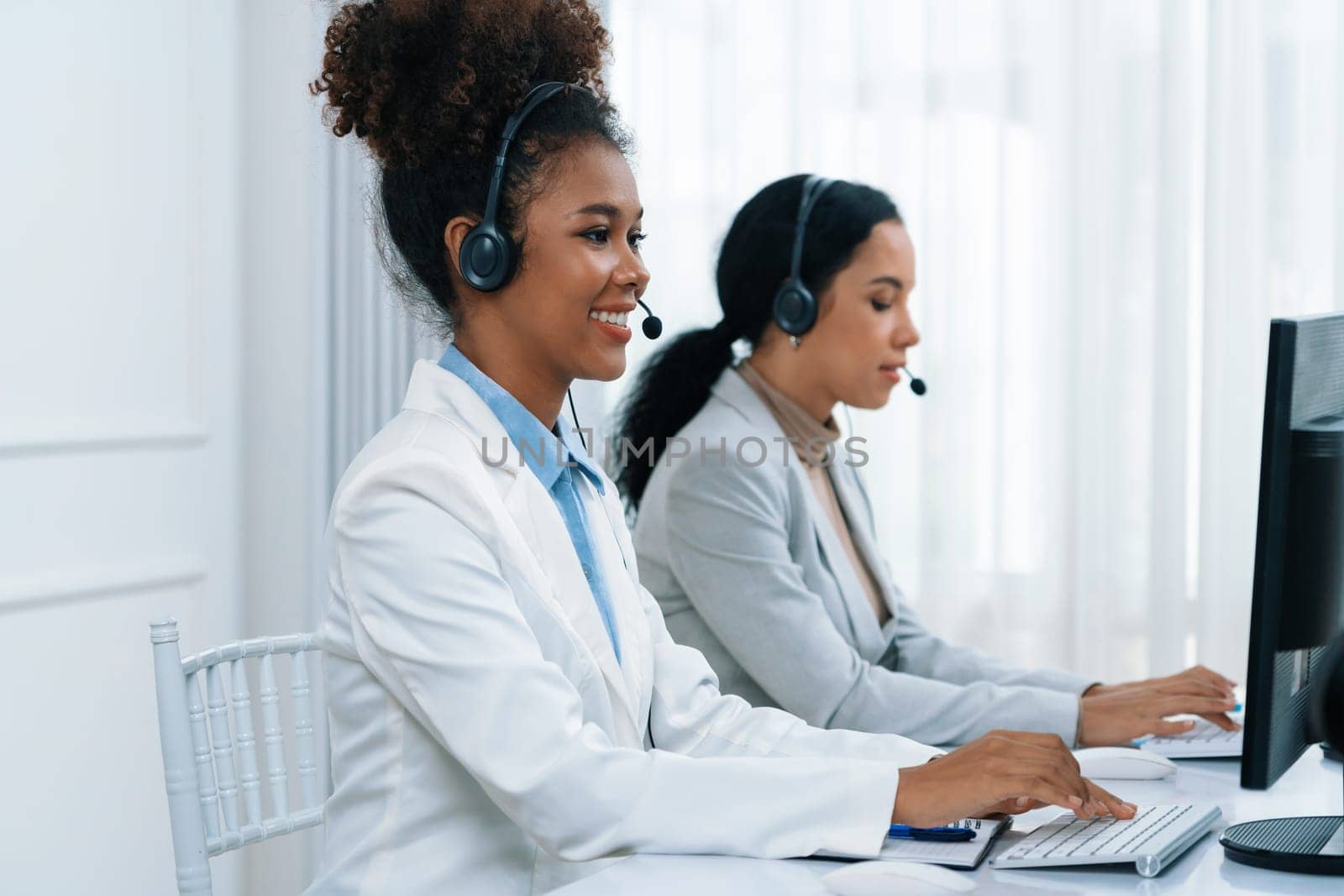 Business people wearing headset working in office to support remote customer or colleague. Call center, telemarketing, customer support agent provide service on telephone video conference call crucial