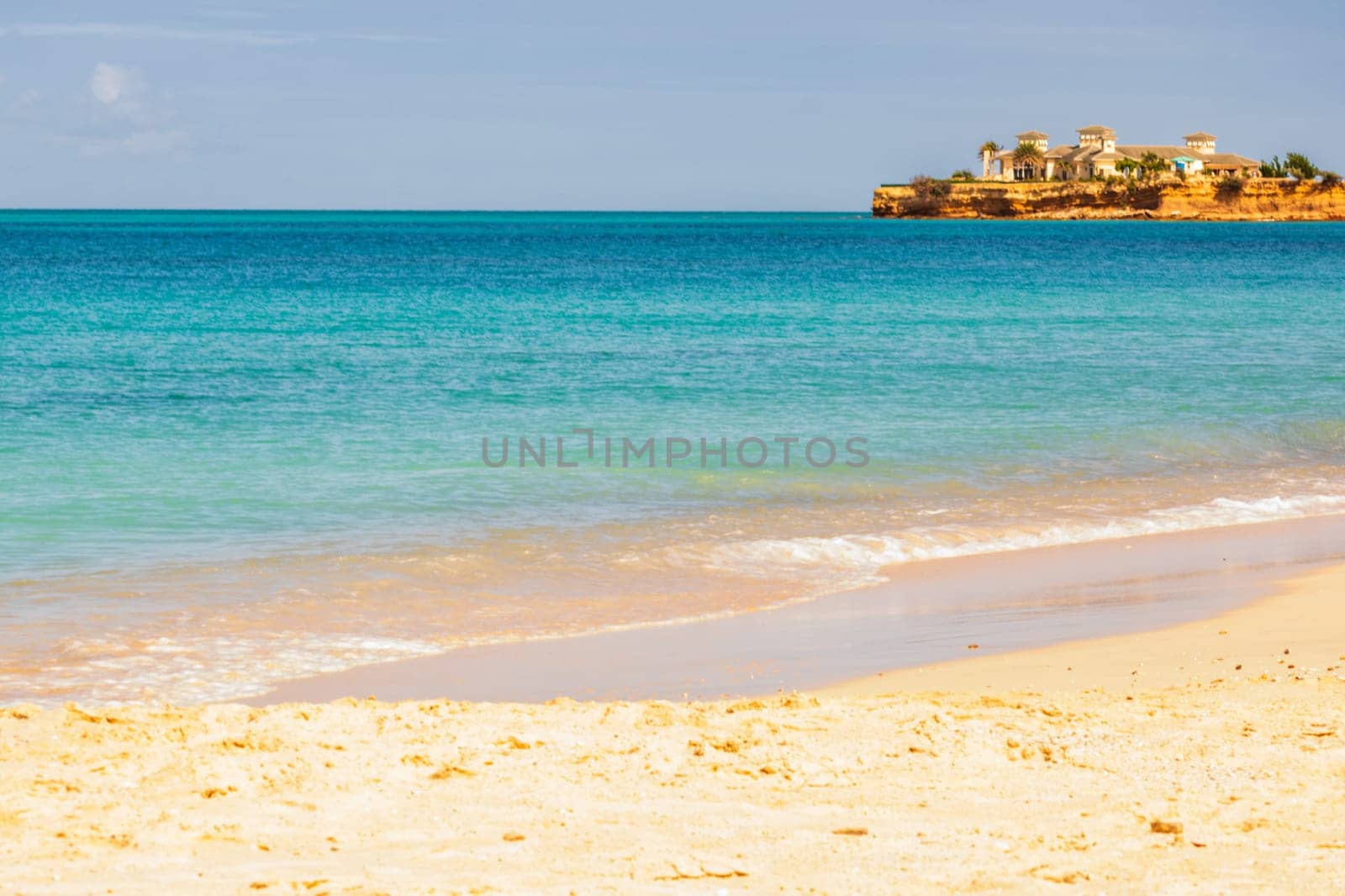 Caribbean beach with white sand, deep blue sky and turquoise water