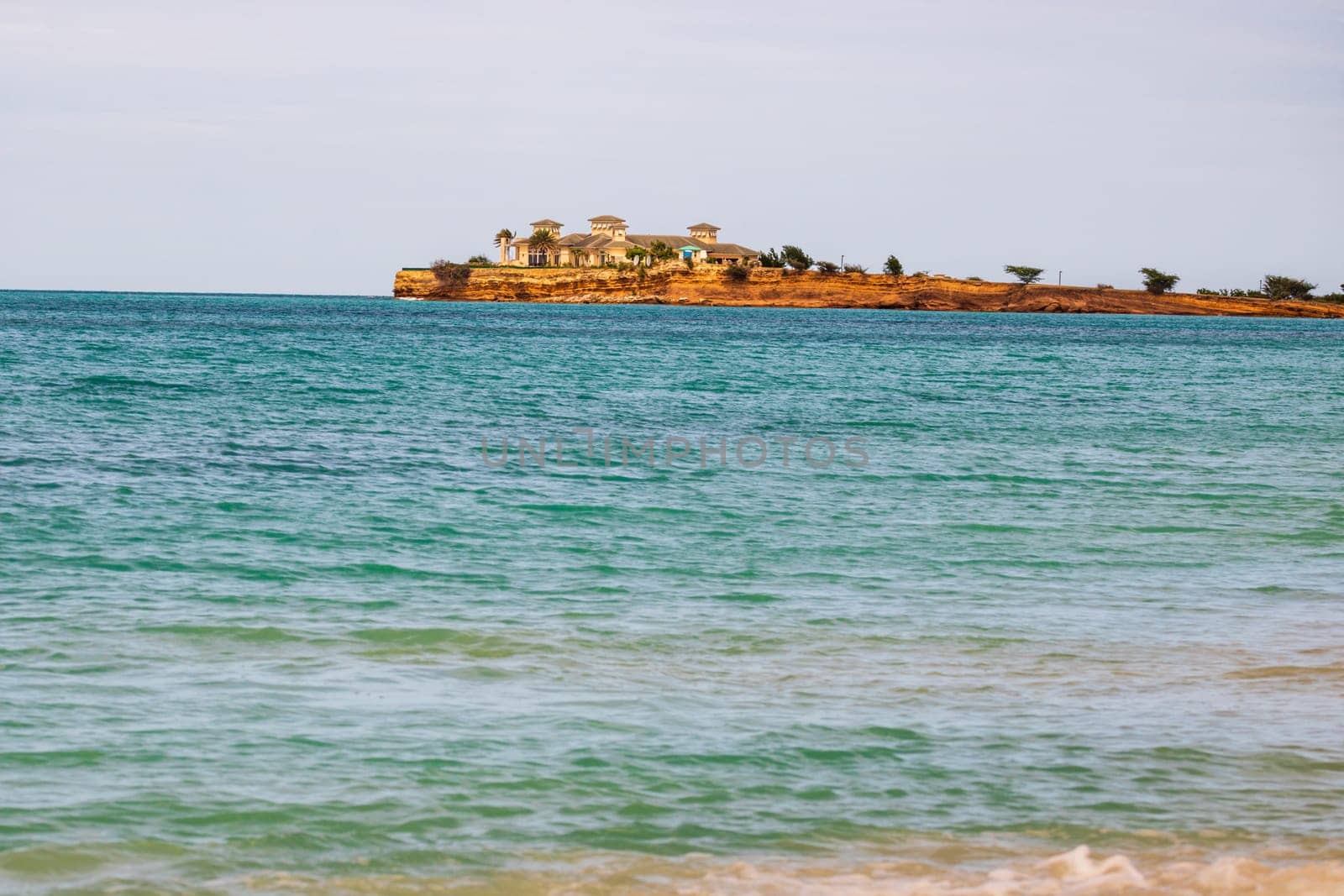 Caribbean beach with white sand, deep blue sky and turquoise water