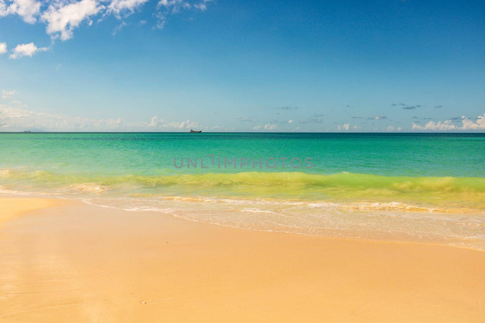 Caribbean beach with white sand, deep blue sky and turquoise water