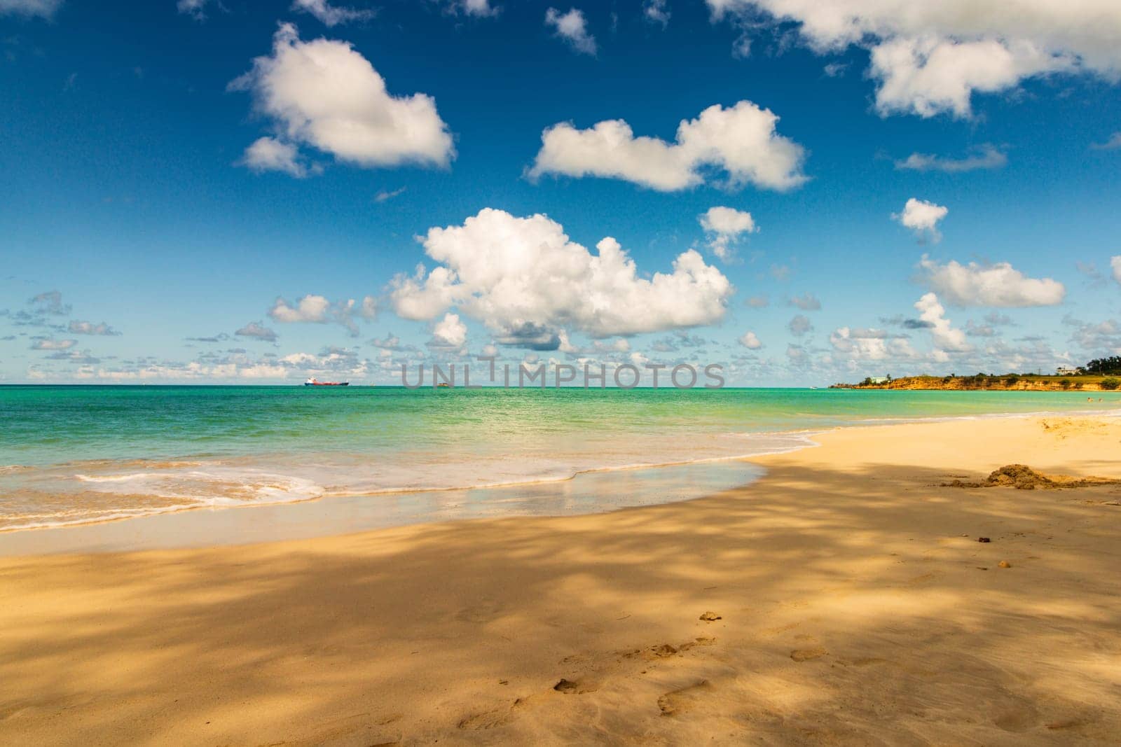 Caribbean beach with white sand, deep blue sky and turquoise water