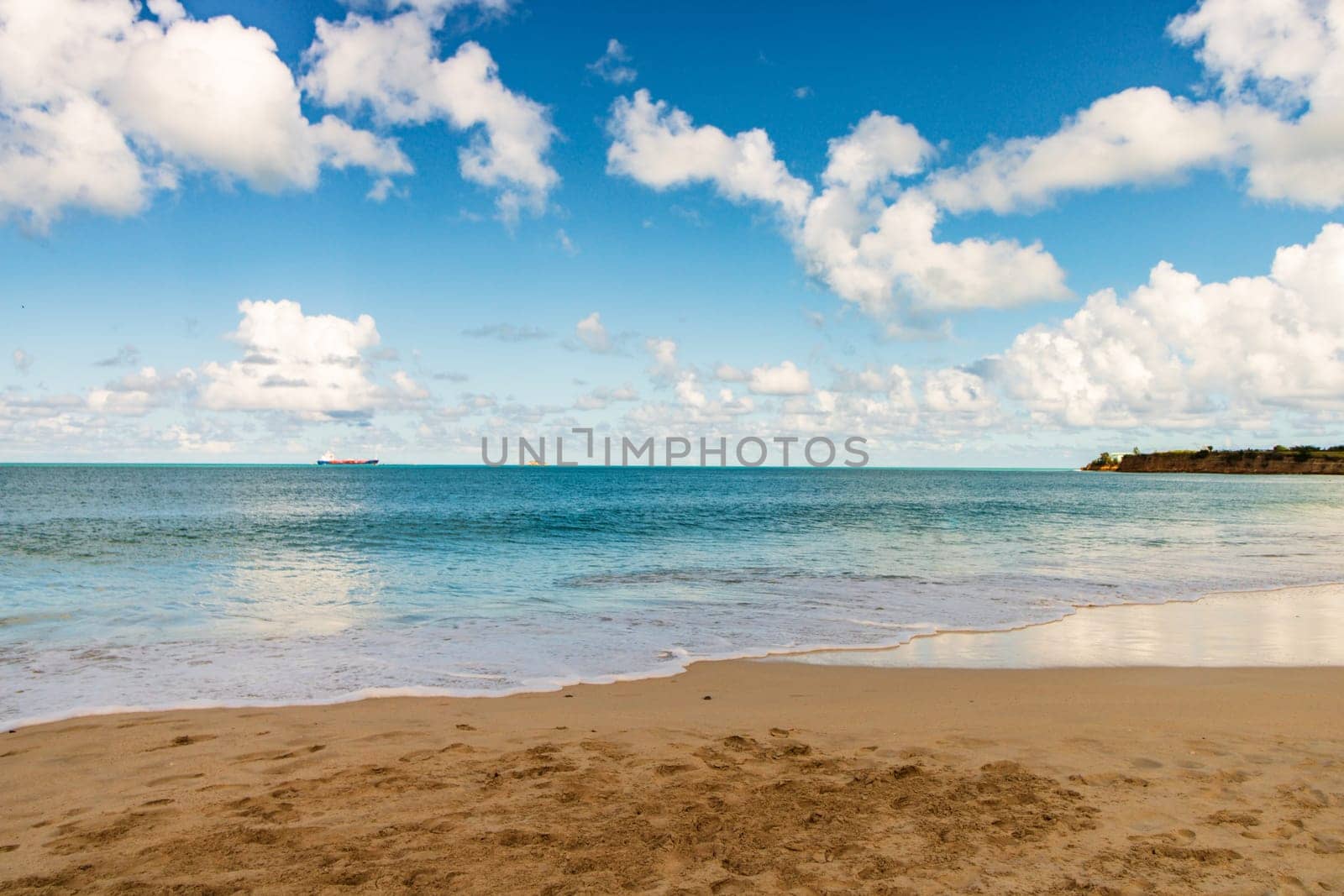 Caribbean beach with white sand, deep blue sky and turquoise water