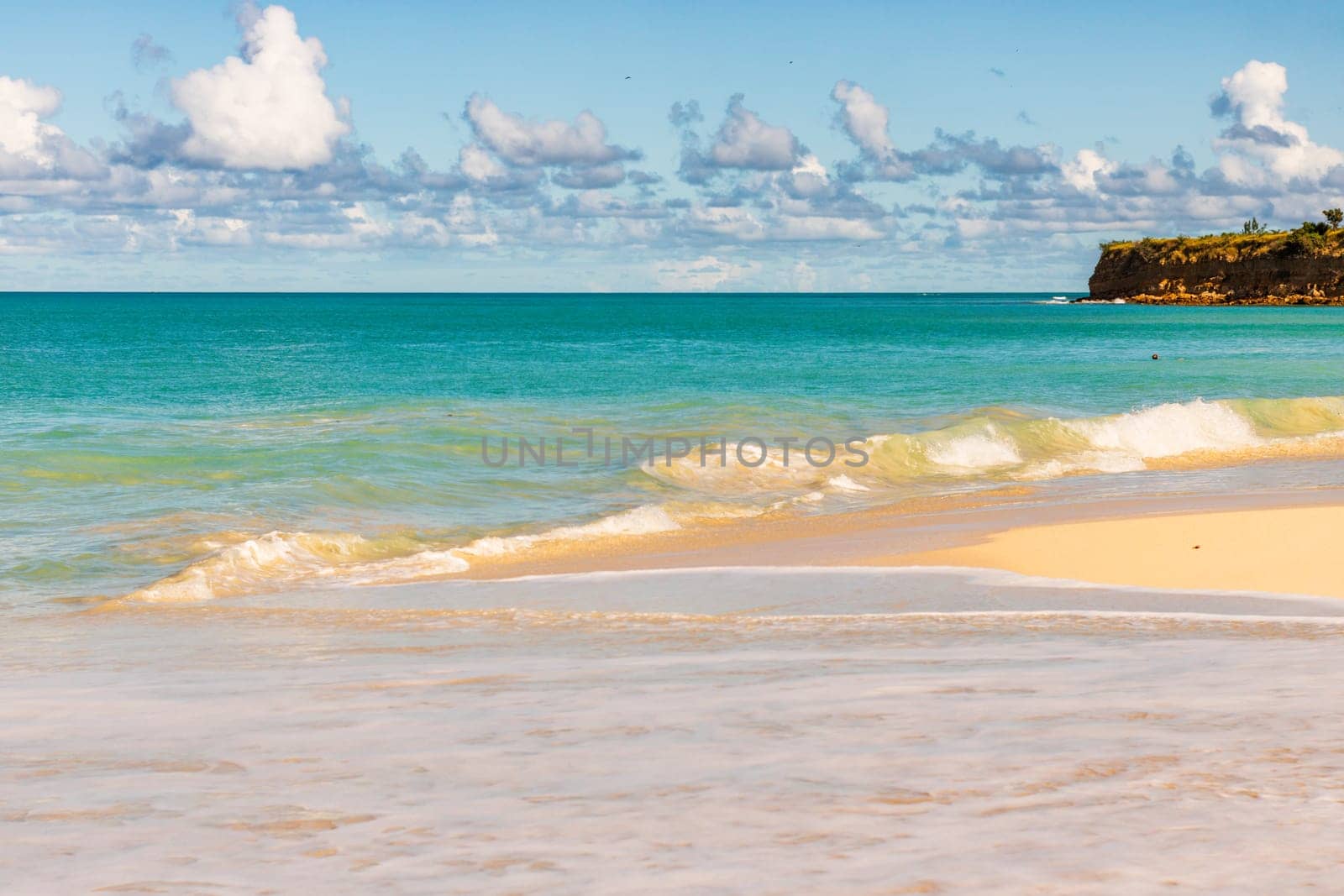 Caribbean beach with white sand, deep blue sky and turquoise water