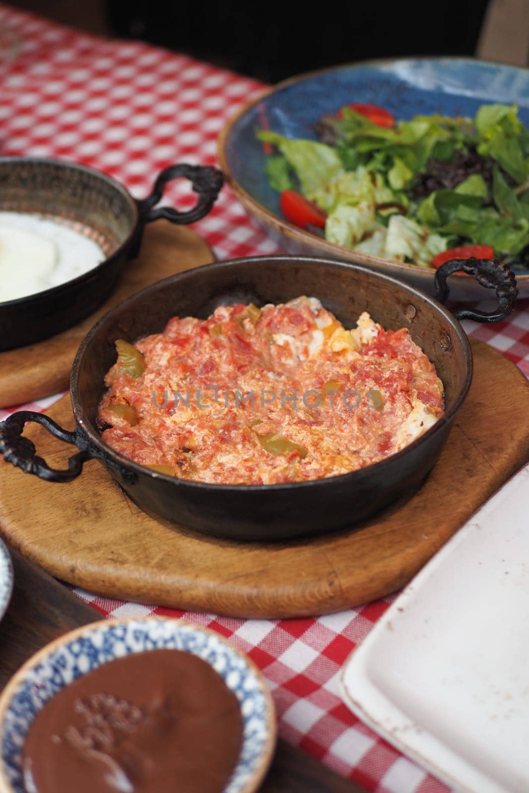 Turkish Menemen omelet in a frying pan.