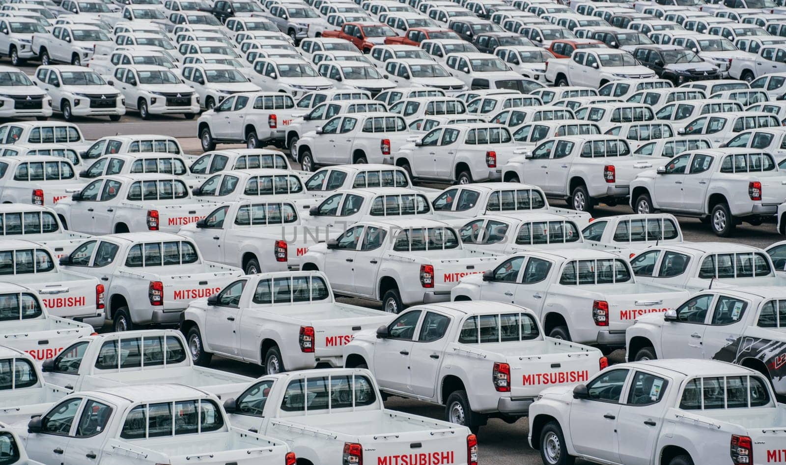 Lamchabang, Thailand - July 02, 2023 distribution center at car factory on a cloudy day, new hatchbacks are neatly lined up. top view offers a glimpse of the bustling parkinga hub of modern business.