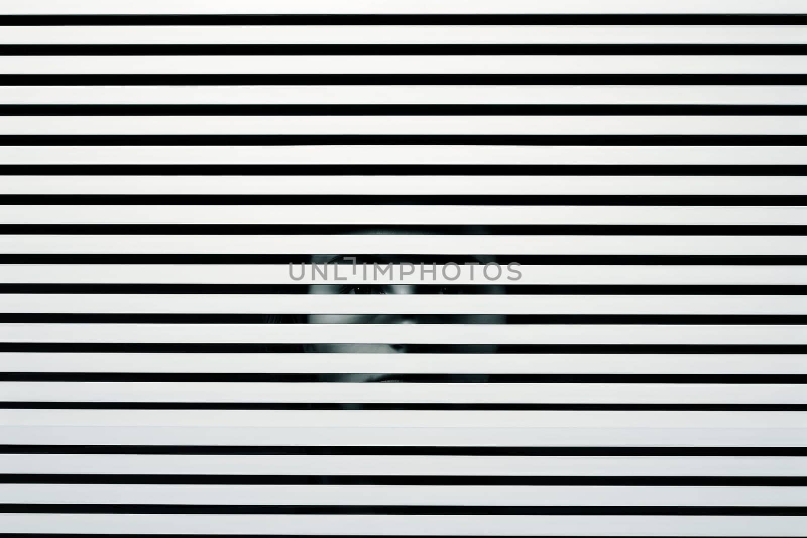 Scary eye peek out of strip lines abstract concept of unhappy vision minimal comeliness