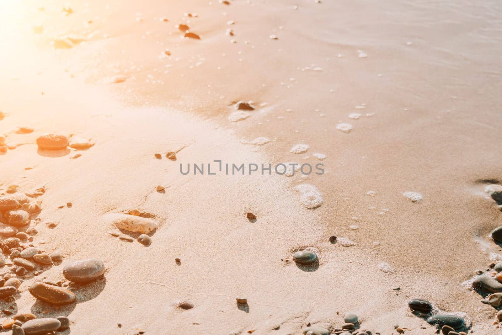 Abstract sea summer ocean sunset nature background. Sound of small waves on golden water surface in motion blur with golden bokeh lights from sun. Holiday, vacation and recreational concept.