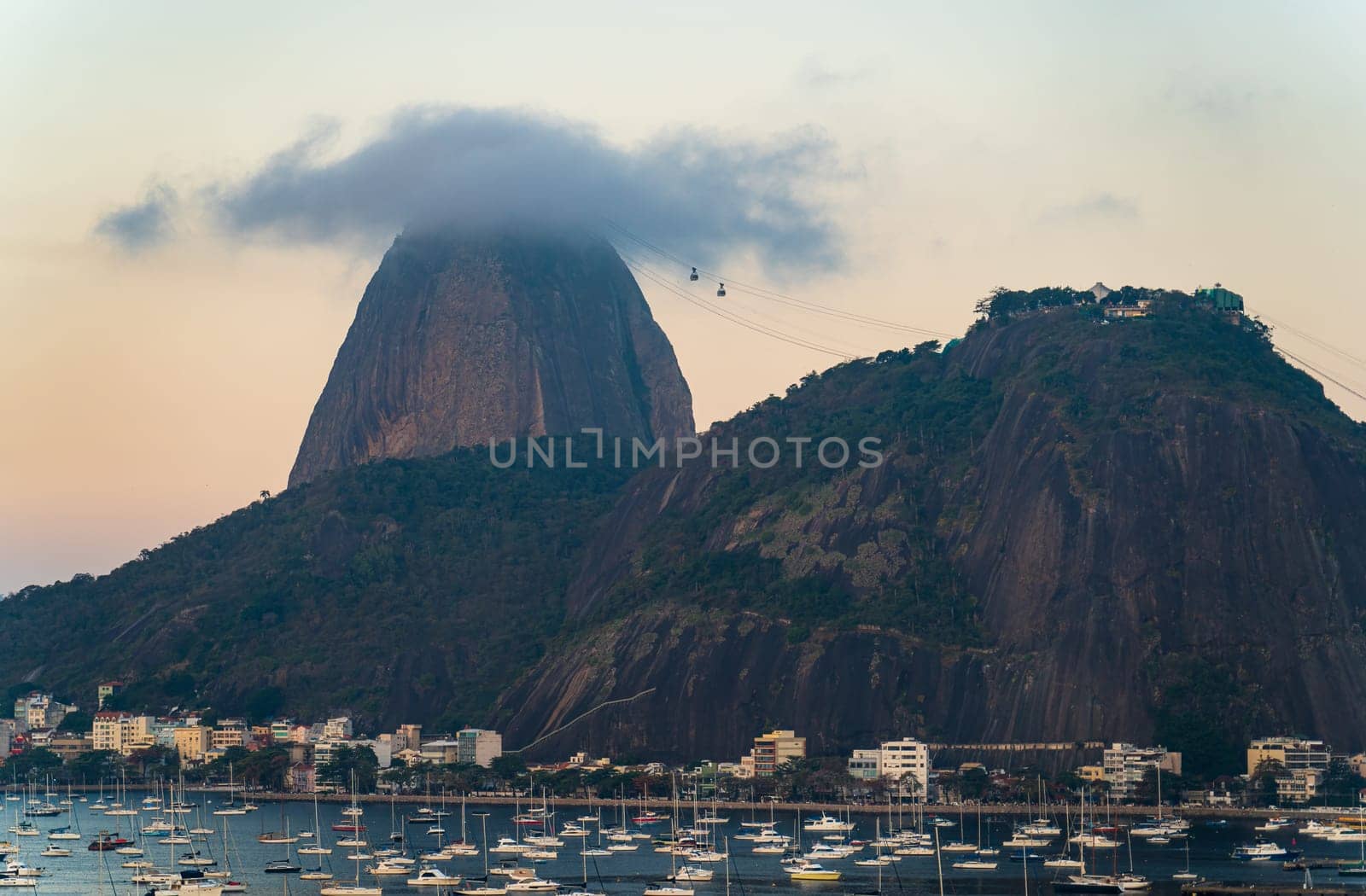 Twilight blankets Rio as cable cars climb Sugarloaf Mt.