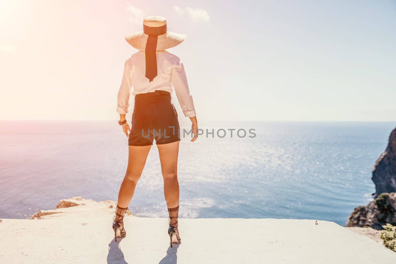 Happy girl doing yoga with laptop working at the beach. beautiful and calm business woman sitting with a laptop in a summer cafe in the lotus position meditating and relaxing. freelance girl remote work beach paradise