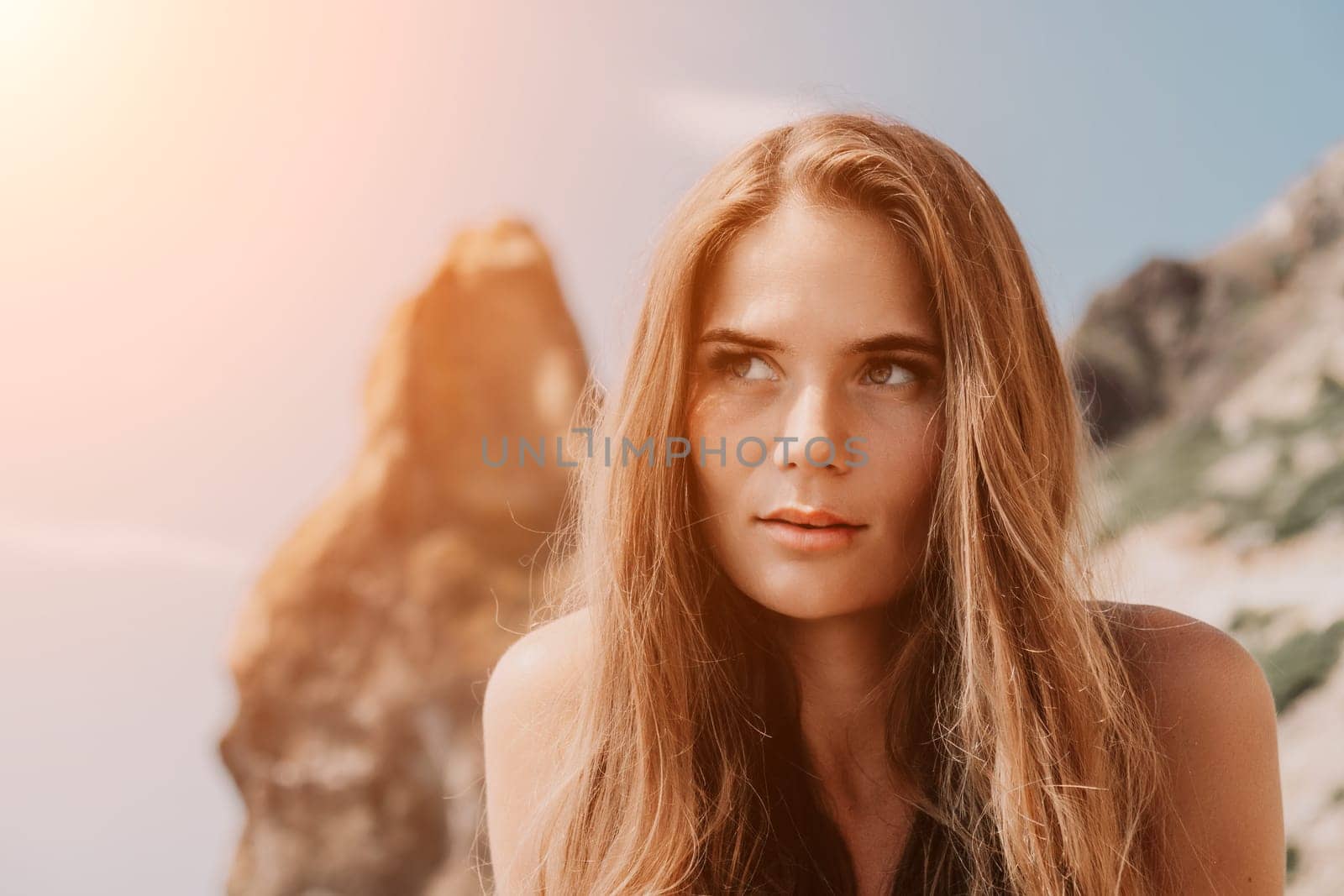 Woman summer travel sea. Happy tourist enjoy taking picture outdoors for memories. Woman traveler posing on the beach at sea surrounded by volcanic mountains, sharing travel adventure journey by panophotograph