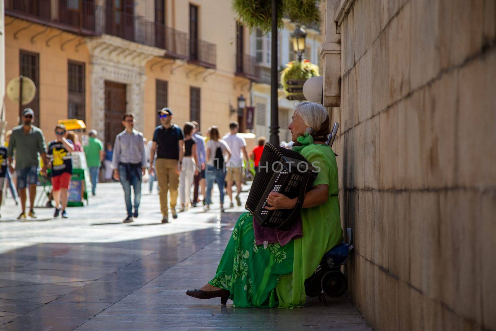 Malaga, Spain - May 25, 2019: A street musician performing in the historic city center.