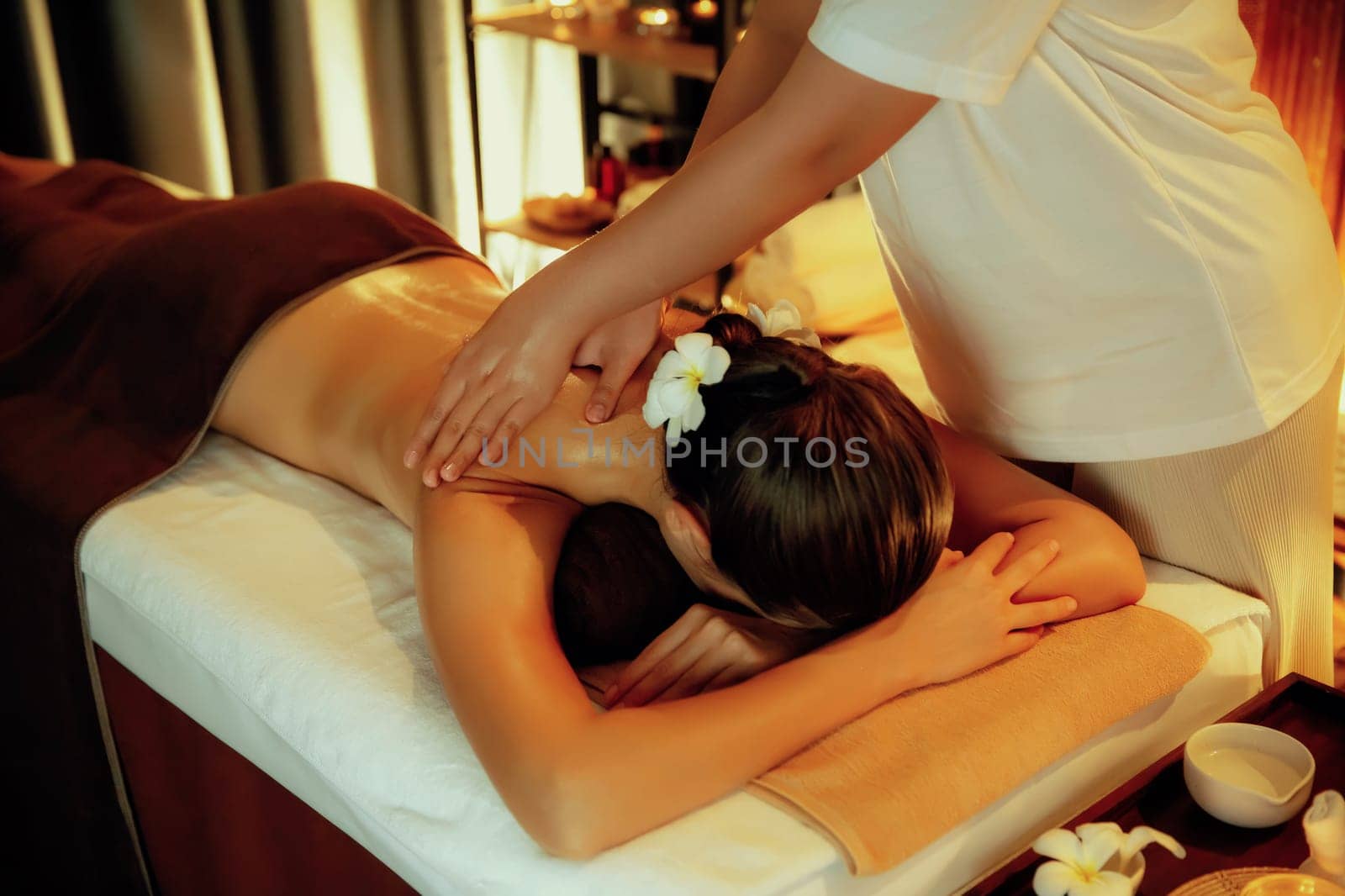 Caucasian woman customer enjoying relaxing anti-stress massage. Quiescent by biancoblue