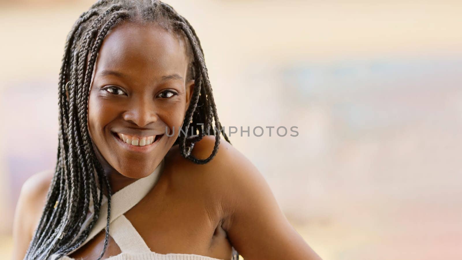 African and young woman smiling at the camera by ivanmoreno