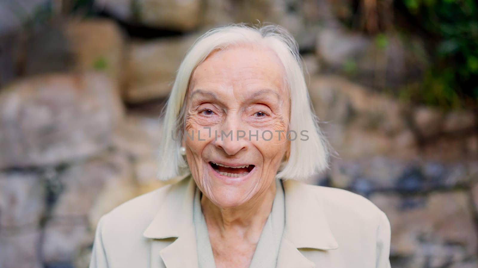 Close up portrait of a great grandmother smiling at camera in a nursing home