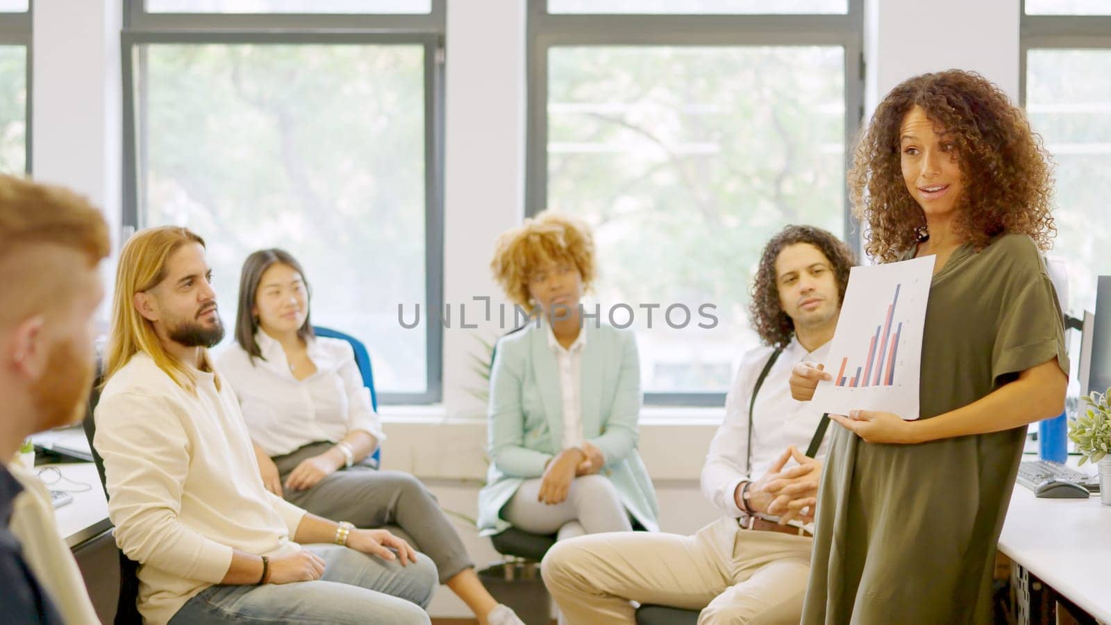 Female manager showing data using graphics during a meeting in the coworking office