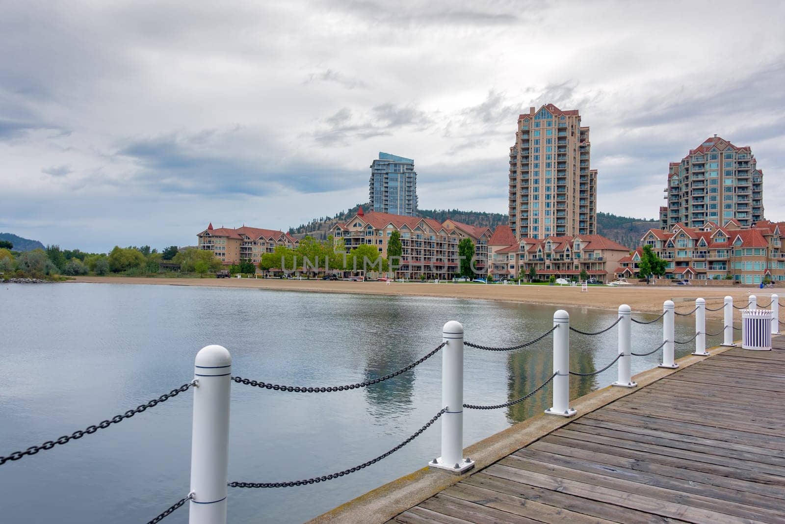 Wooden boardwalk along the waterfront on Okanagan lake in Kelowna, British Columbia.