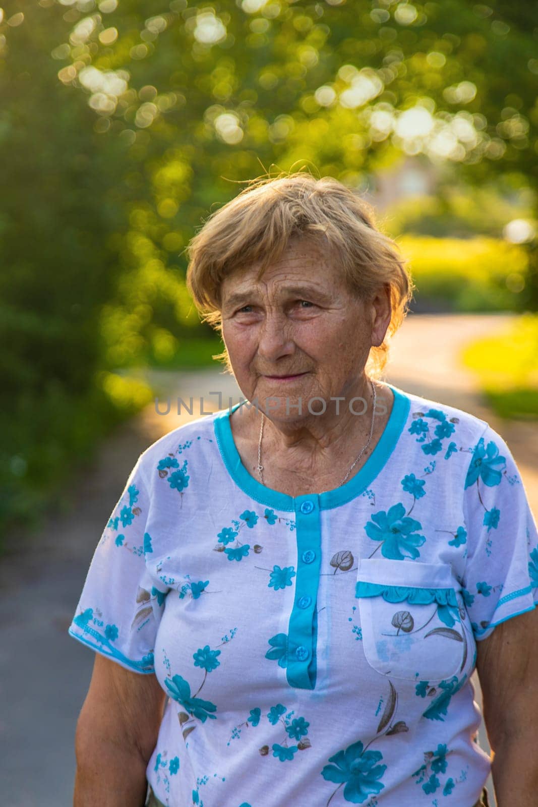 Old woman in the garden. Selective focus. Nature.