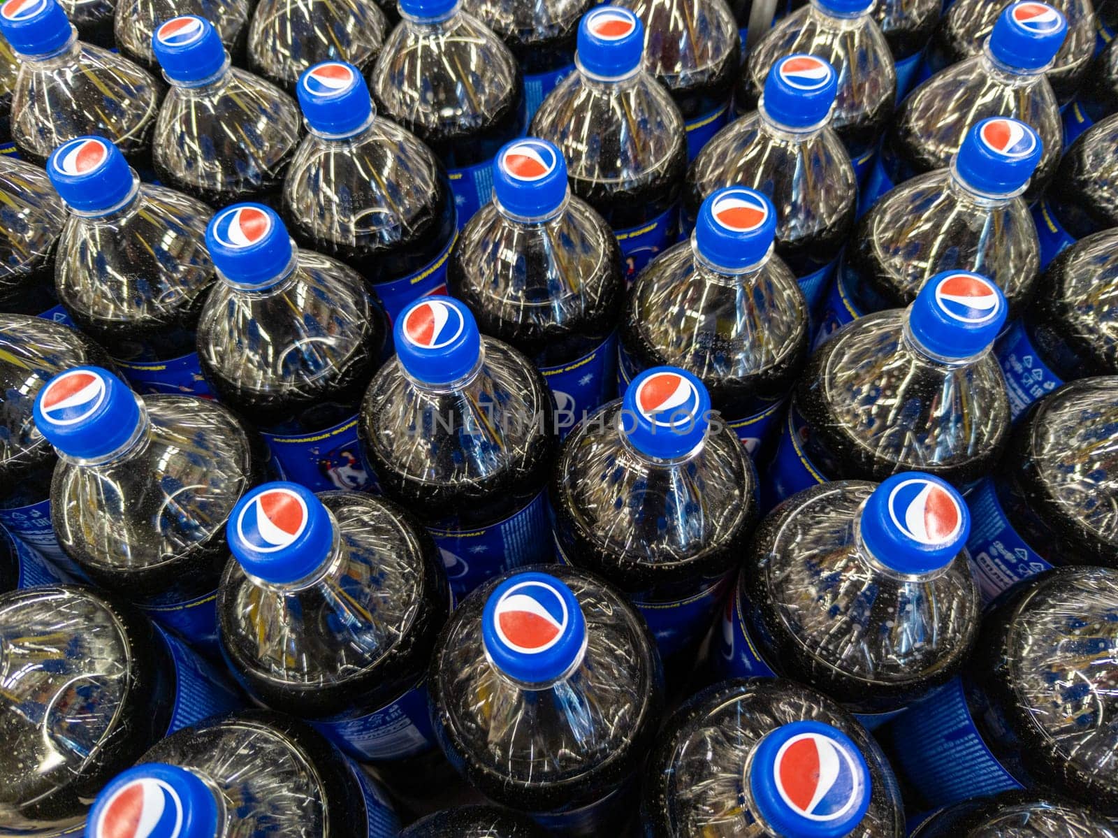 Rows of plastic Pepsi bottles, close-up full-frame high angle view in Sokuluk, Kyrgyzstan: November 16, 2022