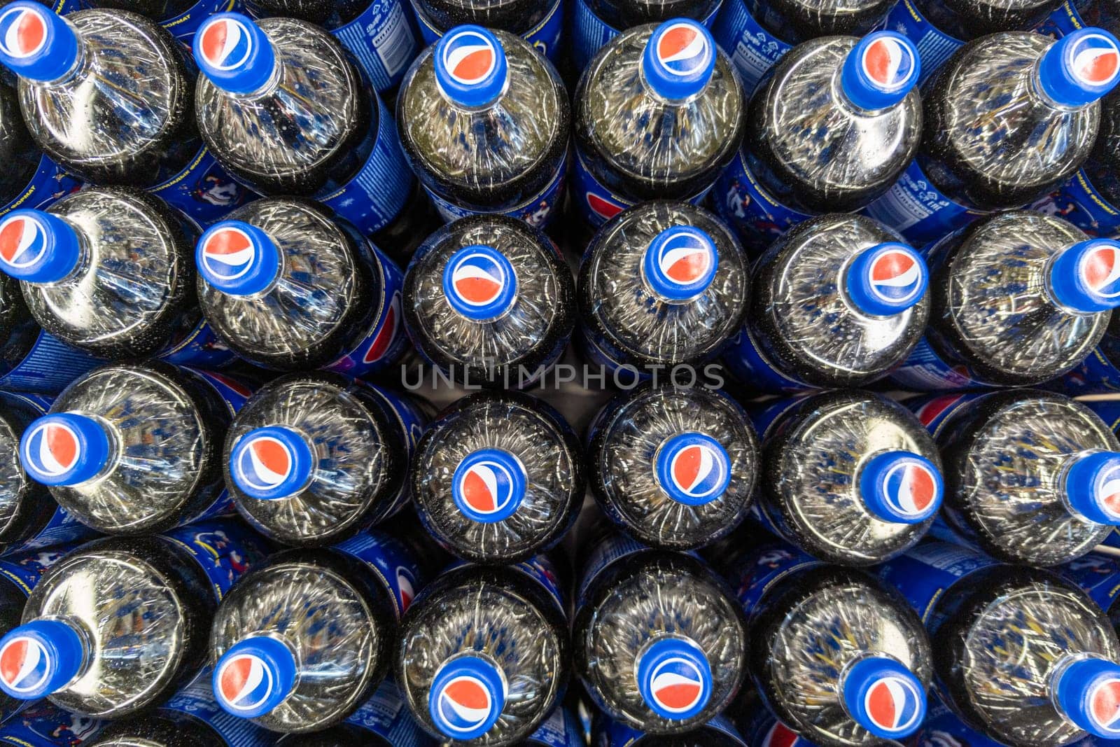 Rows of plastic Pepsi bottles, close-up full-frame high angle view in Sokuluk, Kyrgyzstan: November 16, 2022