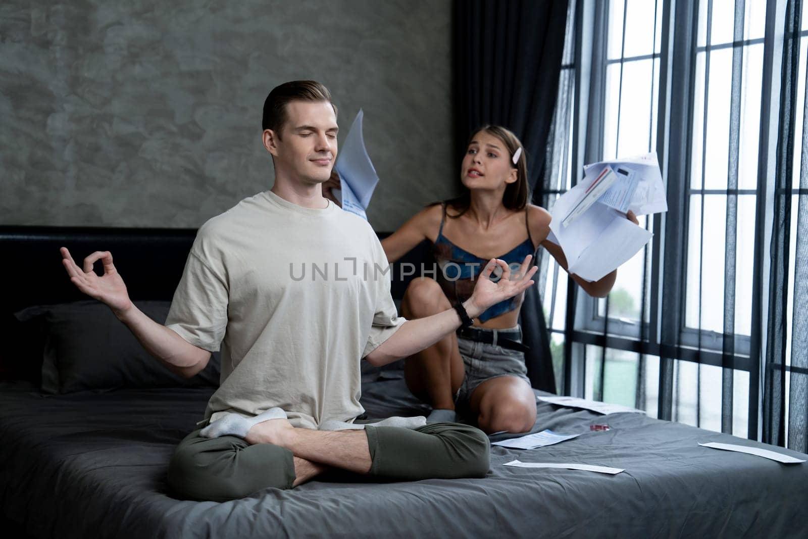 Young man doing mindfulness and peacefulness meditation ignoring problem while his wife or lover yelling with frustrated and upset expression. Marriage problem ignorant lifestyle. Unveiling