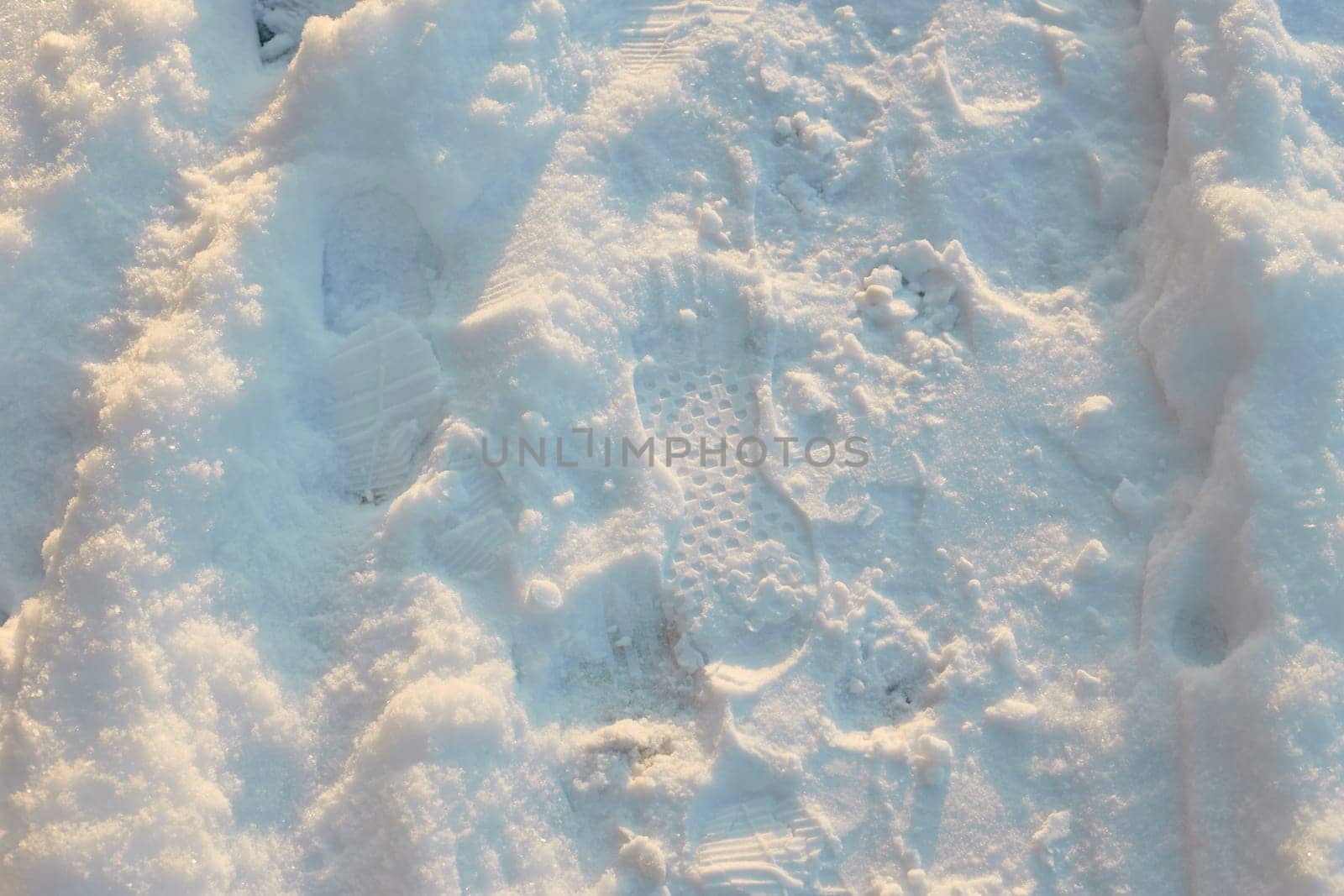 photo footprints from winter boots in the snow on a sunny frosty day. Prints.