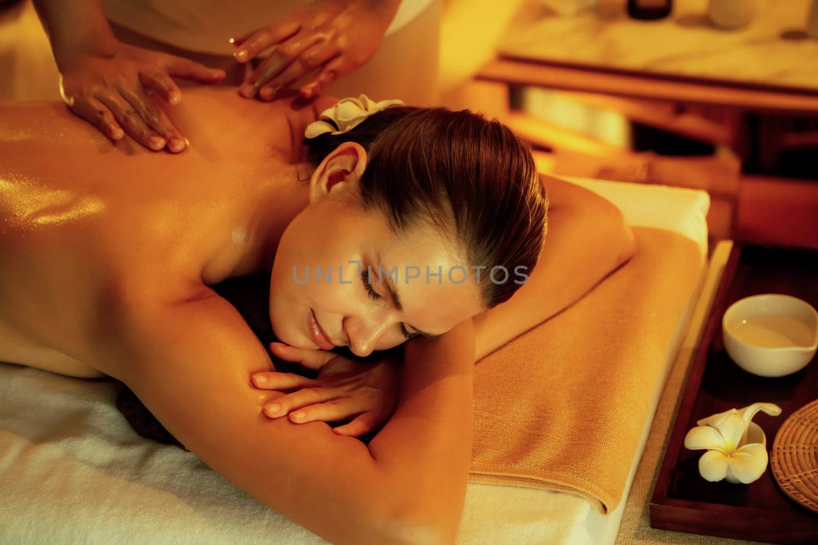 Caucasian woman customer enjoying relaxing anti-stress massage. Quiescent by biancoblue