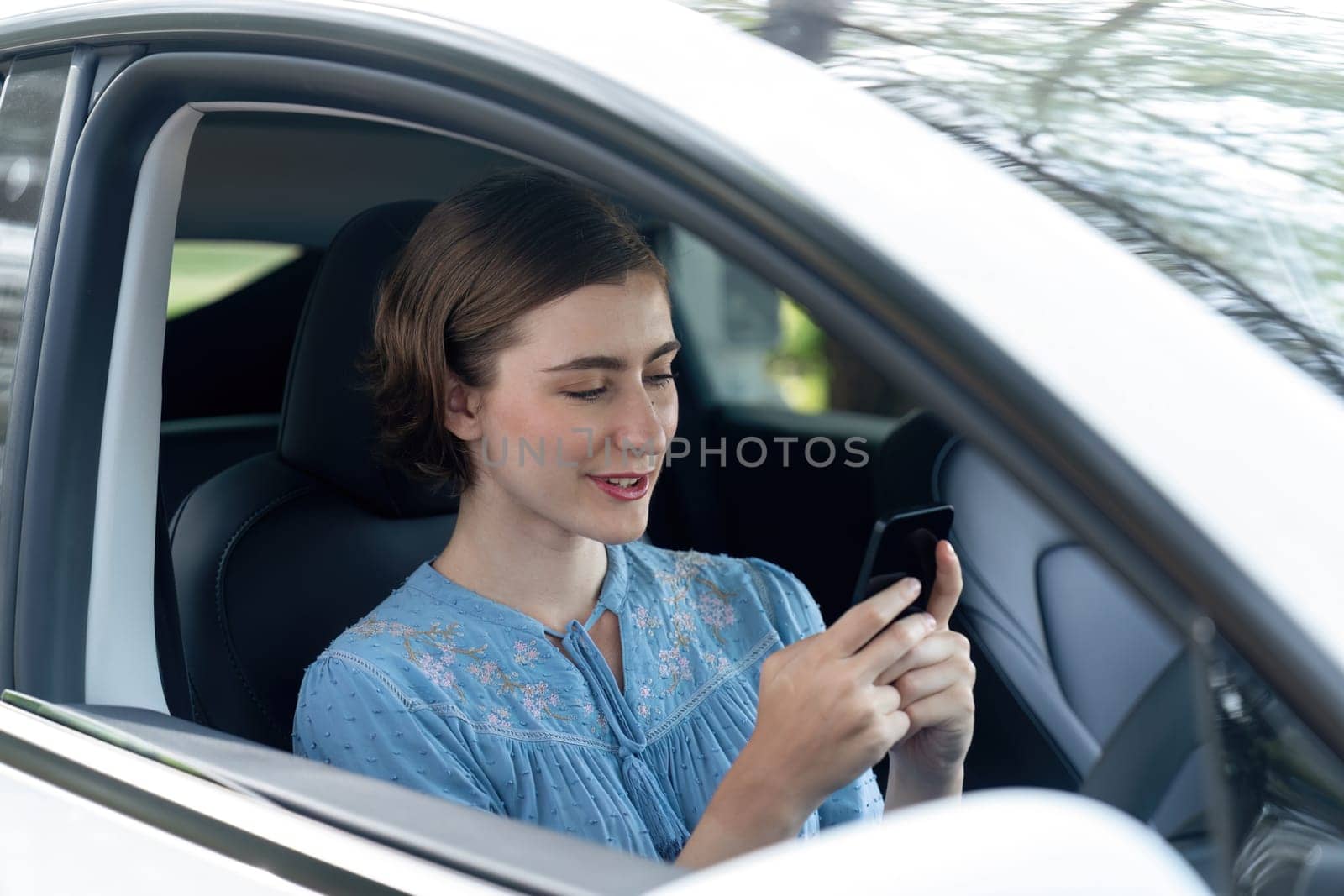 Beautiful woman in casual wear sitting on driver seat portrait. Cute girl driving a car concept with happy expression and pleasant smiling. Young woman with car road trip lifestyle. Perpetual