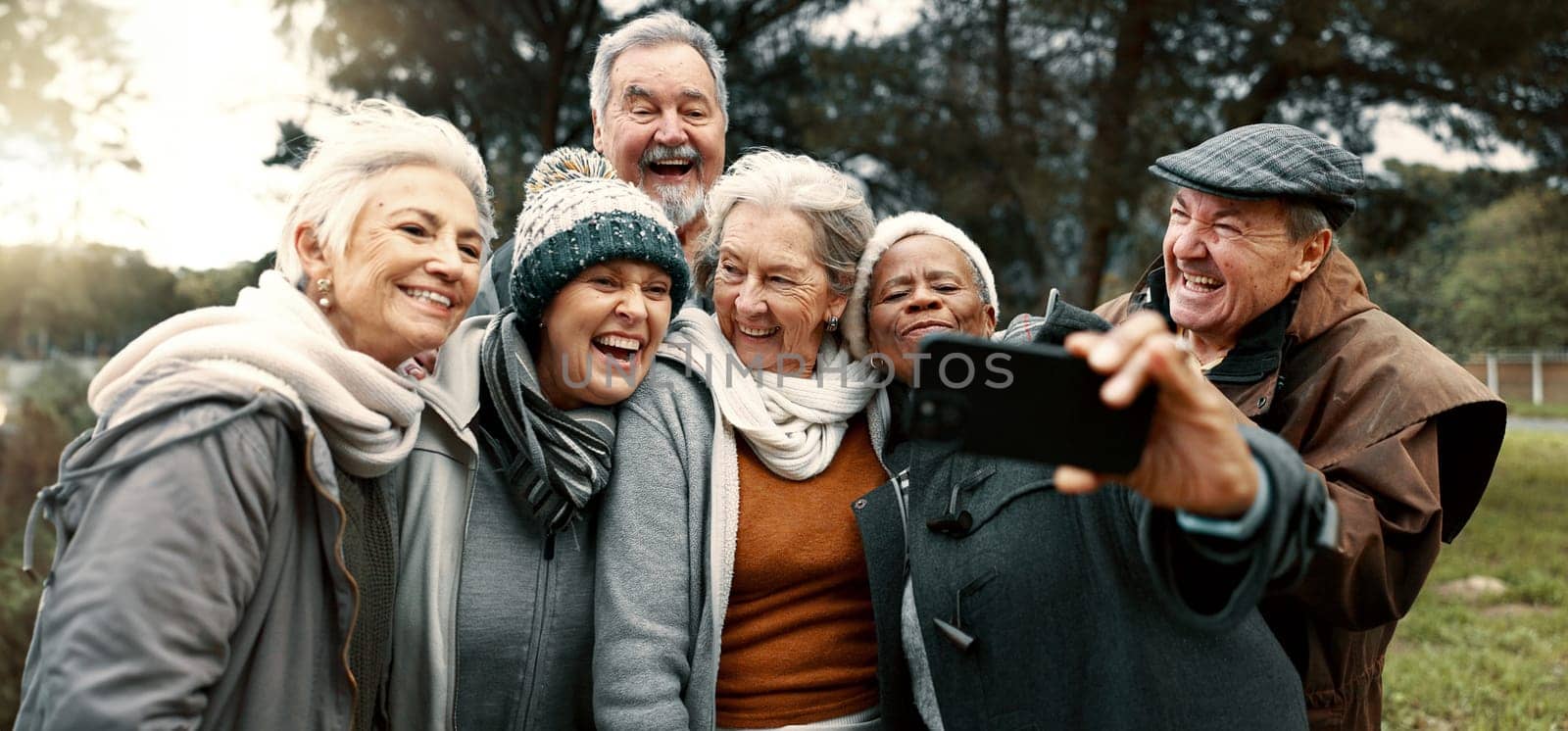 Excited, selfie and group of senior friends in outdoor green environment for fresh air. Diversity, happy and elderly people in retirement taking picture together while exploring and bonding in a park by YuriArcurs
