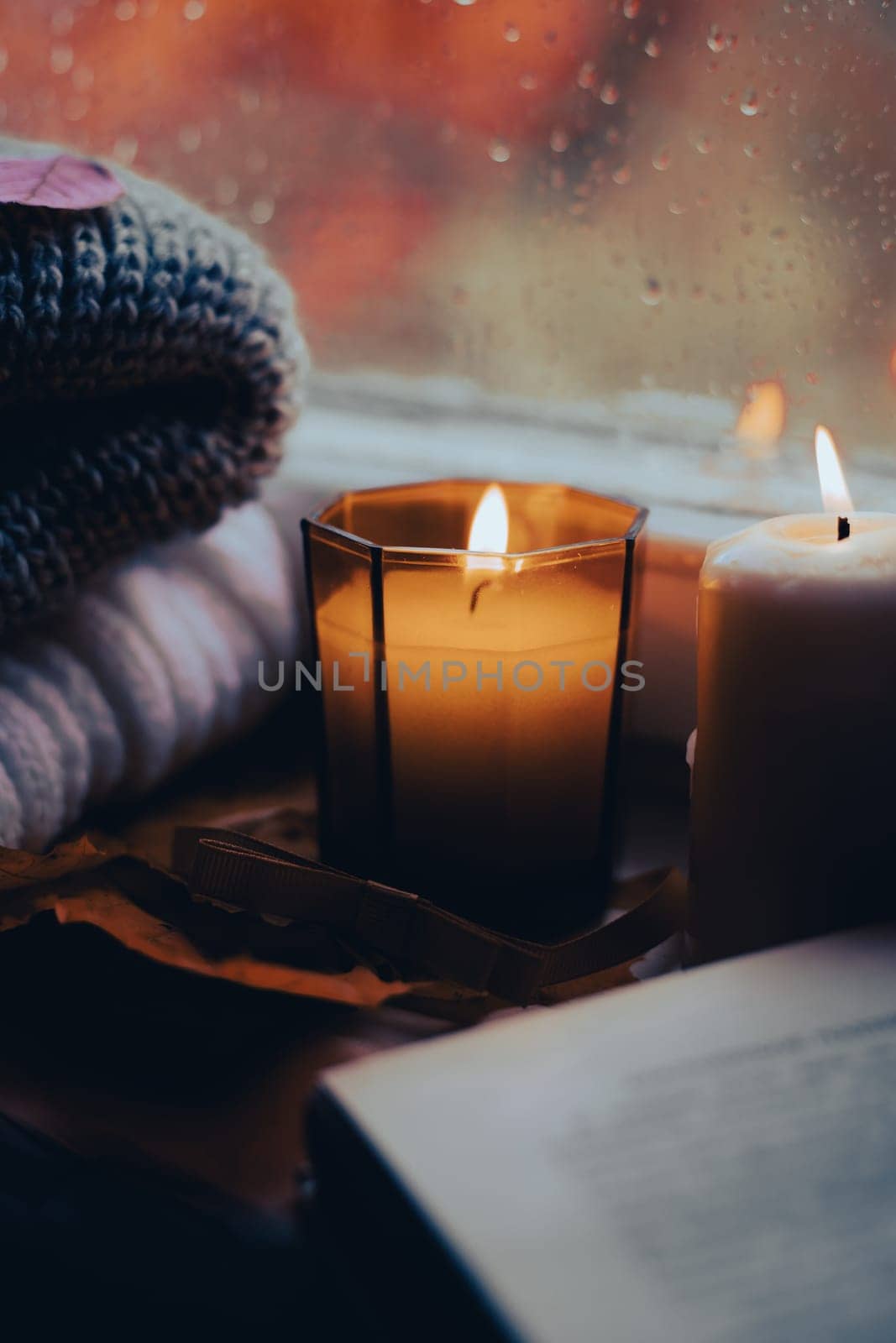 A burning candle on the window is autumn . the comfort of home . autumn comfort . autumn mood. The chondra . cozy vibes by alenka2194